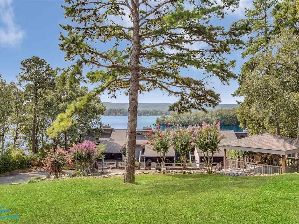 Wall of Glass to Enjoy Unobstructed Southerly Views From This Outstanding Lake Condo!  completely Remodeled and it is Gorgeous.  A Vacation Place You Will Call Home and Not Want to Leave!  Featuring 16' Vaulted Ceiling, Massive Stone Fireplace, Granite, Stainless Appliances and Loft For Extra Sleeping.  Corner Unit with Covered Parking, Boat Dock with Lift, See Doo Dock, and Unbelievable, Private, Back Deck!  Sits on 4 Beautiful Acres, Gated Complex and Wonderful Pool!  This One Is the Best of the Best!