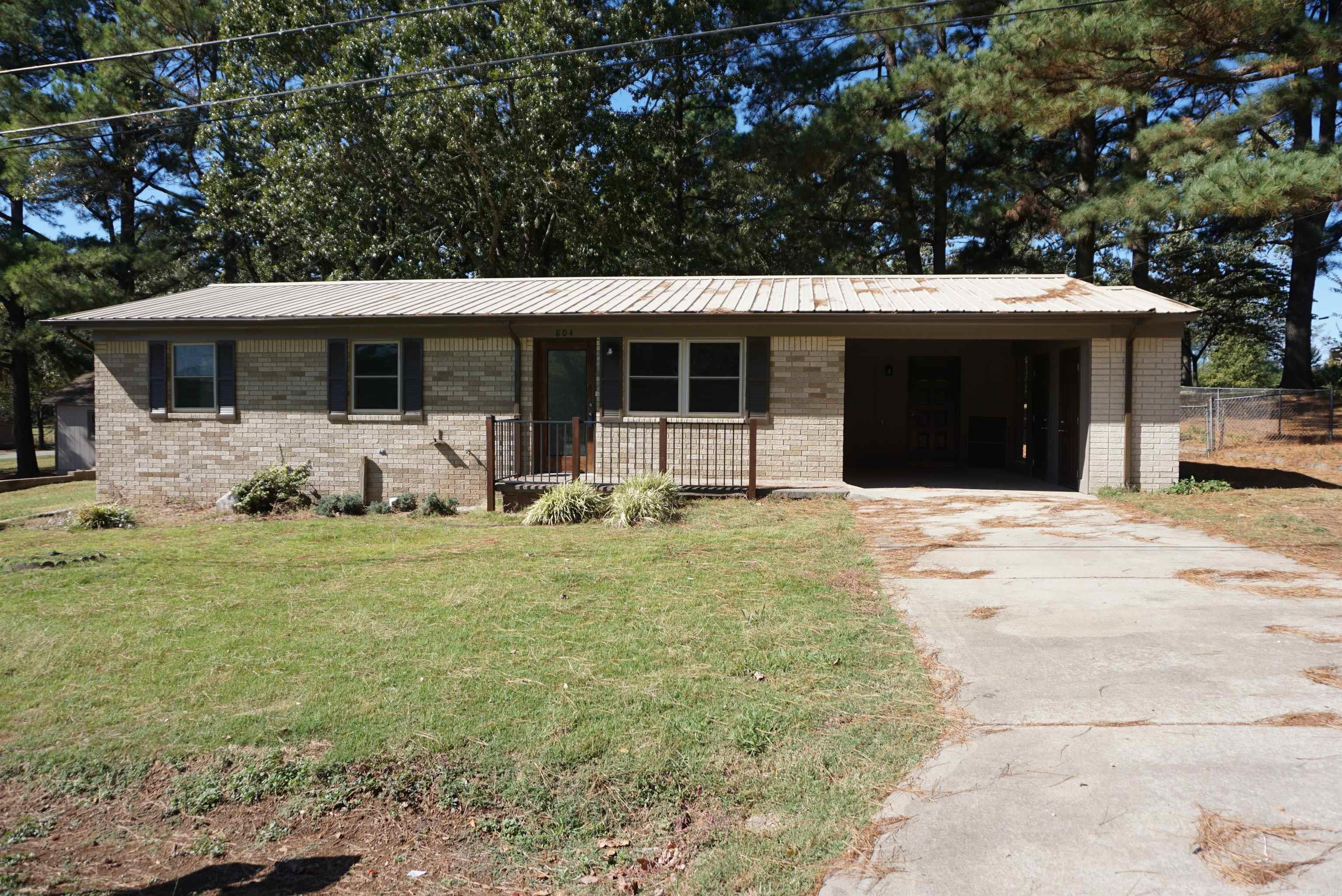Beautiful remodel with New cabinets, countertops, LVP flooring throughout, fresh paint, new windows and lighting. New appliances will be included in the kitchen. Large laundry room with walk in pantry, kitchen/dining is very open to the living room for entertaining. There are 2 primary suites each with private bathrooms. 1 has a walk in shower and the other has a large tub/shower combo and walk in closet. The main bathroom has also been updated with new tile and has a tub/shower unit. The back yard is fenced in with gates to the front and side out to the 1st storage building that has a pull up door. The other storage building has a walk door with closets inside. The corner lot is very wide and has a separate drive up to the storage buildings and side yard. Nice storage area in the covered attached carport with built ins.  Very nice brick home and a large yard plus outside storage. Measuring encouraged. Sq ft is different that the CHR due to the addition of square footage during remodel.