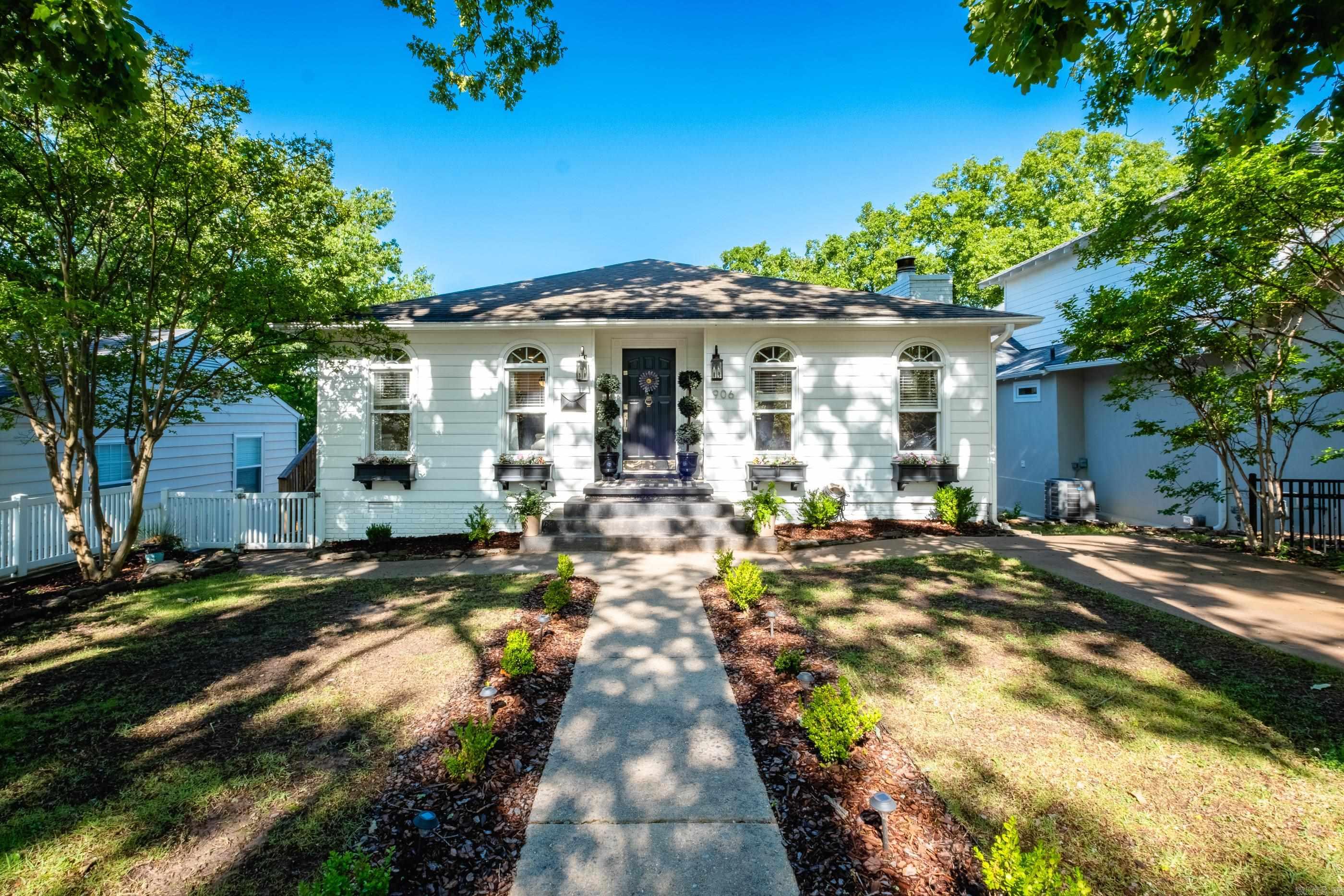 Welcome to 906 N. Polk Street, a beautifully updated Hillcrest gem with room for everyone. This two-story home sits in one of Little Rock’s most loved neighborhoods and is just a short walk from Holy Souls School, local shops, and all the charm Hillcrest is known for. Inside, you’ll find 4 bedrooms and 3 full bathrooms, thoughtfully arranged for comfort and privacy. The main level features the primary suite plus an additional guest bedroom and full bath. Downstairs, two more bedrooms and a full bathroom create the perfect setup for guests, teens, or multigenerational living. The lower level also includes a bonus room that works beautifully as a playroom, media room, or hangout space. It even has its own mini-kitchenette with a sink, microwave, mini-fridge, and storage for dishes — ideal for movie nights or hosting. A cozy gas fireplace anchors the main living area. Outside, you’ll appreciate the newer wooden side-entry stairs, a newer privacy fence, a storage building, and a convenient front parking pad. This home blends comfort, convenience, and Hillcrest character.