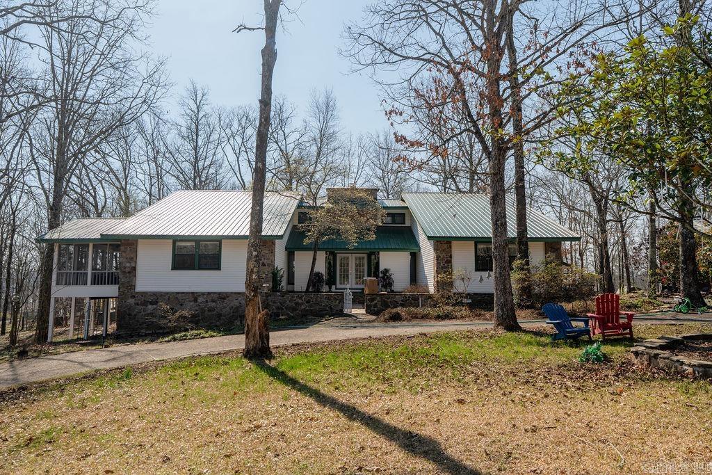 Spacious 4 bedroom, 2.5 bath home on a 2.25-acre corner lot near Greers Ferry Lake, offering approximately 3,200 sq ft of living space and loaded with extras. Inside you’ll find a cozy wood-burning fireplace, sunroom, and a large game/media room complete with a bar—perfect for entertaining. Step outside to enjoy the covered deck with hot tub, ideal for relaxing year-round. The property also features a 20x28 detached garage with an additional 20x20 workshop, a 24x41 drive-through boat or RV storage, a convenient circle drive, and partial fencing. Located in a desirable area close to Devil’s Fork Park and Janssen’s Lakefront Restaurant, this home combines space, function, and proximity to the lake. Beach access from Valhalla Drive in this subdivision.