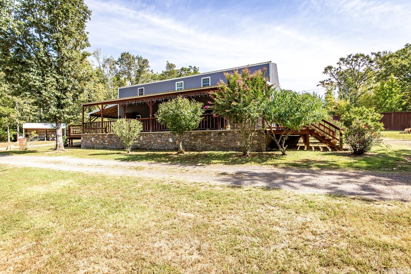 Nestled on approximately 5.33 acres, this magnificent 4-bedroom, 3-bathroom home offers country tranquility with the convenience of being close to town. Boasting a generous 3800 square feet of living space, this residence features an array of amenities, including a two-car garage, a spacious porch for relaxed evenings, and a charming "she shed" or studio for creative endeavors. There is also a shop for a boat, atv, or any extra vehicles. Inside, the home impresses with its thoughtful design and open floorplan that features oversized rooms and closets throughout. The upstairs level has a second laundry area and a bonus room, providing flexibility and additional living space. This home has the perfect space for a large or growing family!