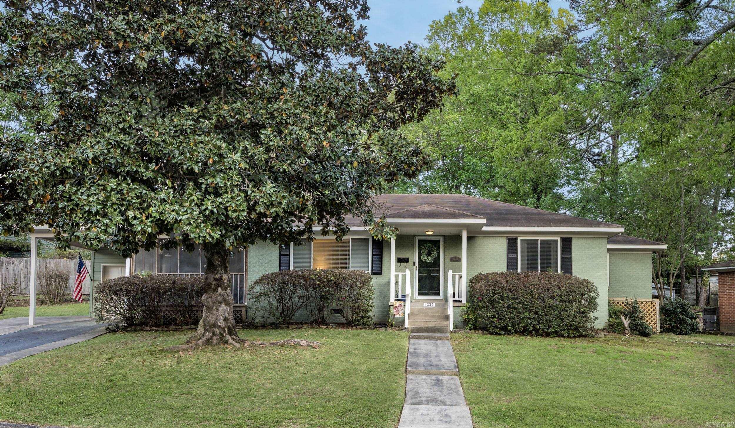 Welcome to this charming 2 bedroom, 1 bathroom all brick bungalow in the highly sought-after Kingwood neighborhood! Move-in ready and full of character, this home features beautiful hardwood floors, abundant natural light, an oversized kitchen with abundant cabinetry, separate dining room, and a large living area perfect for entertaining. Enjoy two spacious bedrooms, a bright sunroom, and relaxing screened-in porch overlooking the spacious backyard. The property also includes a 1-car garage with washer and dryer plus an additional carport for convenience. Located near shopping, dining, parks, and downtown Little Rock, this Kingwood gem offers comfort, charm, and location. Schedule your private showing today before it’s gone!