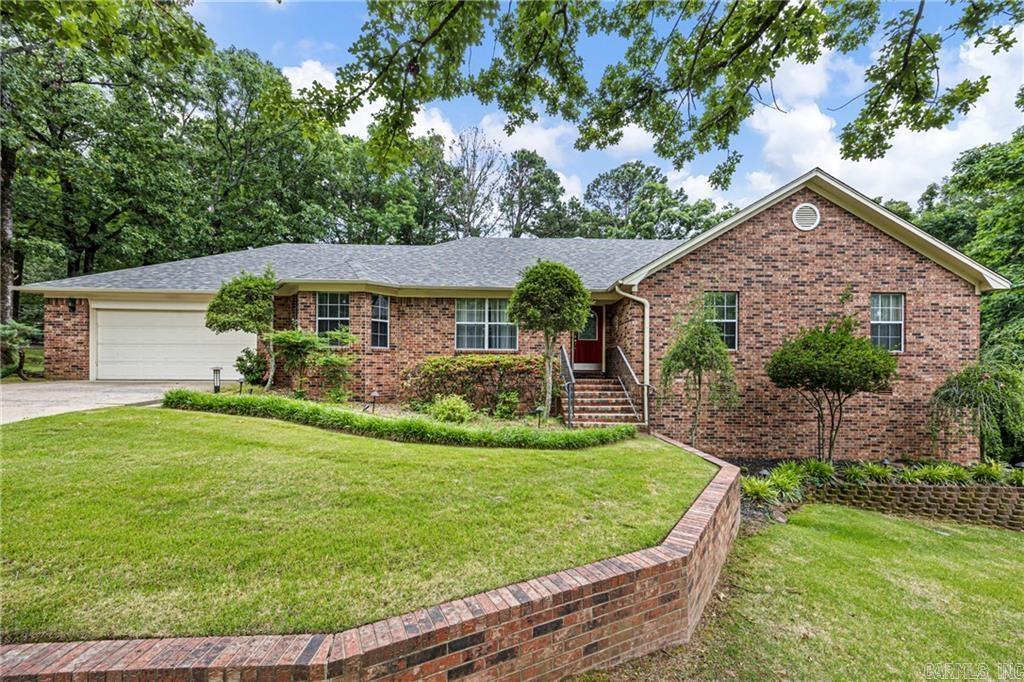 Charming 3 Bedroom, 2.5 bath home nestled in a desirable established neighborhood in western Russellville, this beautifully maintained home offers comfort, space, and privacy. Situated on a large wooded lot with mature trees, landscaping, and a Rainbird sprinkler system, the outdoor setting is just as impressive as the interior. Inside, you’ll find a spacious living room featuring a cozy fireplace, beautiful hardwood floors and natural light. Just off the living area is an additional study/sunroom, perfect for a home office. The updated kitchen is designed for both function and style with granite countertops, newer appliances, glass-top stove, wall-mounted oven and microwave, pantry, formal dining room, and eat-in breakfast area. The spacious master suite includes a walk-in closet plus additional closet for extra storage. The updated master bath features a custom tiled walk-in shower. A convenient half bath is located in the oversized laundry room. Extra storage space off the garage and in crawl space. A must-see!