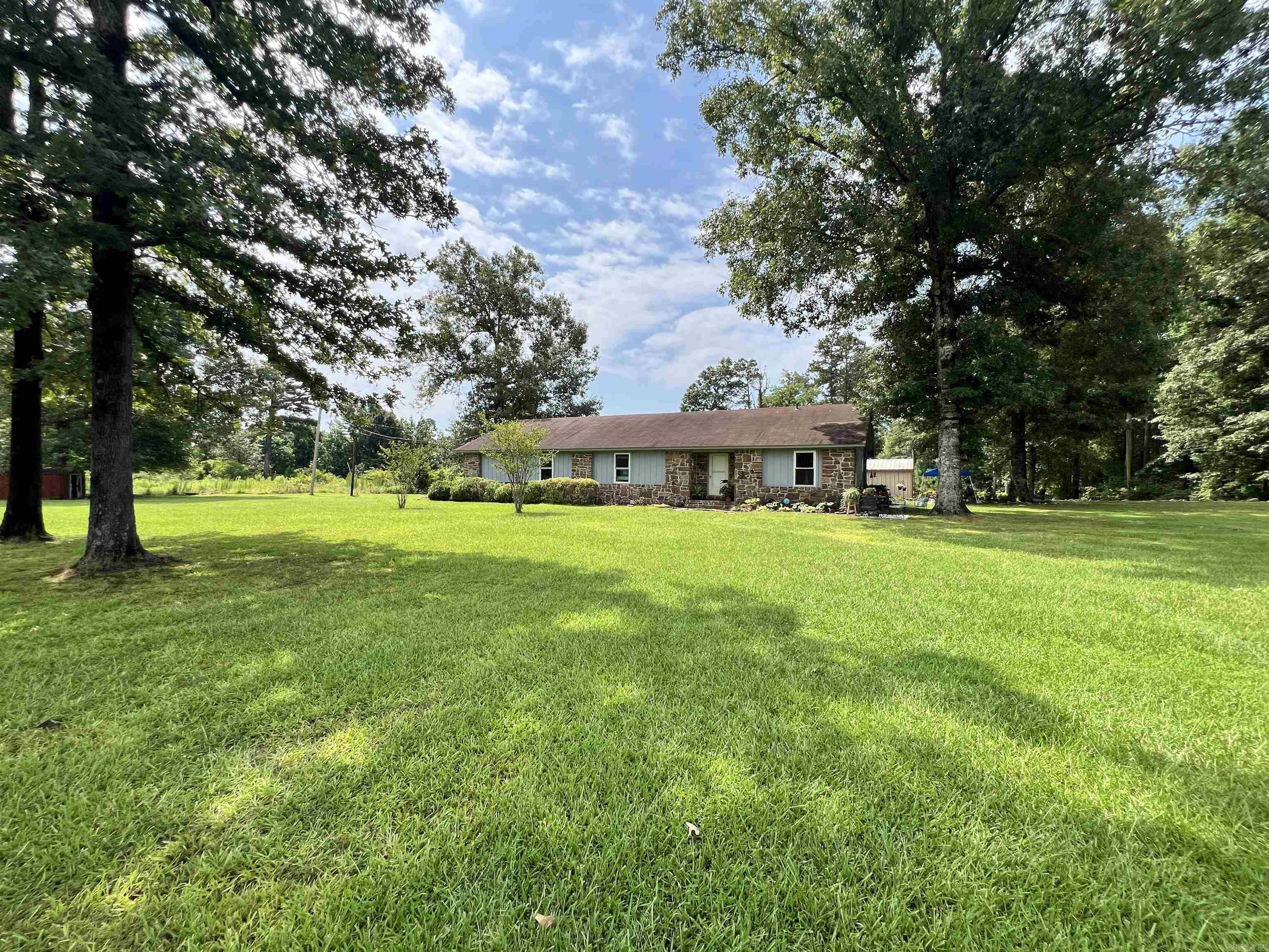 Escape to the peace and privacy of country living with this beautiful 2,776 sq. ft. home nestled on 12.52 picturesque acres. This spacious 3-bedroom, 2-bath home offers the perfect blend of comfort and functionality. The heart of the home is the oversized kitchen featuring gorgeous quartz countertops, an impressive 8-foot island, abundant cabinetry, and plenty of room for gathering with family and friends.  Inside, you’ll find beautiful hardwood flooring, a cozy stone fireplace, a bright sunroom perfect for enjoying the surrounding views, a dedicated craft room/bonus room, and two large pantries providing exceptional storage.  Step outside and discover everything this property has to offer, including a 20x30 workshop, gated pasture ideal for livestock or horses, a storm cellar, and a storage shed. Whether you’re looking for a hobby farm, a place to spread out, or simply a peaceful retreat, this property delivers.  Enjoy the beauty, privacy, and endless possibilities of country living while still being within convenient reach of town. Don’t miss your opportunity to own this exceptional rural property!