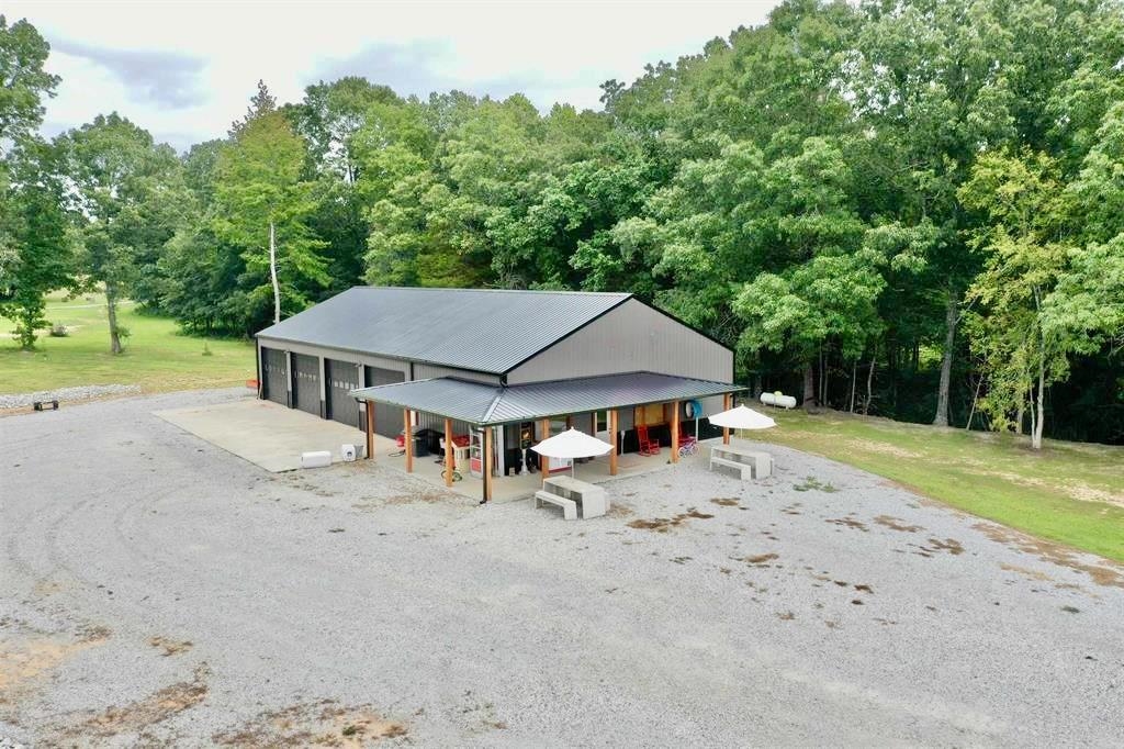 Exceptional 10-acre property located just off Old Fort Road in Melbourne, featuring a 40x80 fully finished shop with 12-foot walls. The shop is thoughtfully designed with an entertainment area that includes a full kitchen, full bathroom, and a spacious game room/living area, ideal for gatherings or future conversion to living space. Four bay doors provide ample storage and easy access for vehicles or equipment.  The acreage is all open and usable, complete with a pond, and offers plenty of room to build a home or expand.