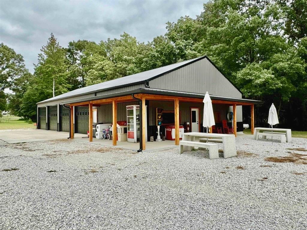 Exceptional 10-acre property located just off Old Fort Road in Melbourne, featuring a 40x80 fully finished shop with 12-foot walls. The shop is thoughtfully designed with an entertainment area that includes a full kitchen, full bathroom, and a spacious game room/living area, ideal for gatherings or future conversion to living space. Four bay doors provide ample storage and easy access for vehicles or equipment.  The acreage is all open and usable, complete with a pond, and offers plenty of room to build a home or expand.