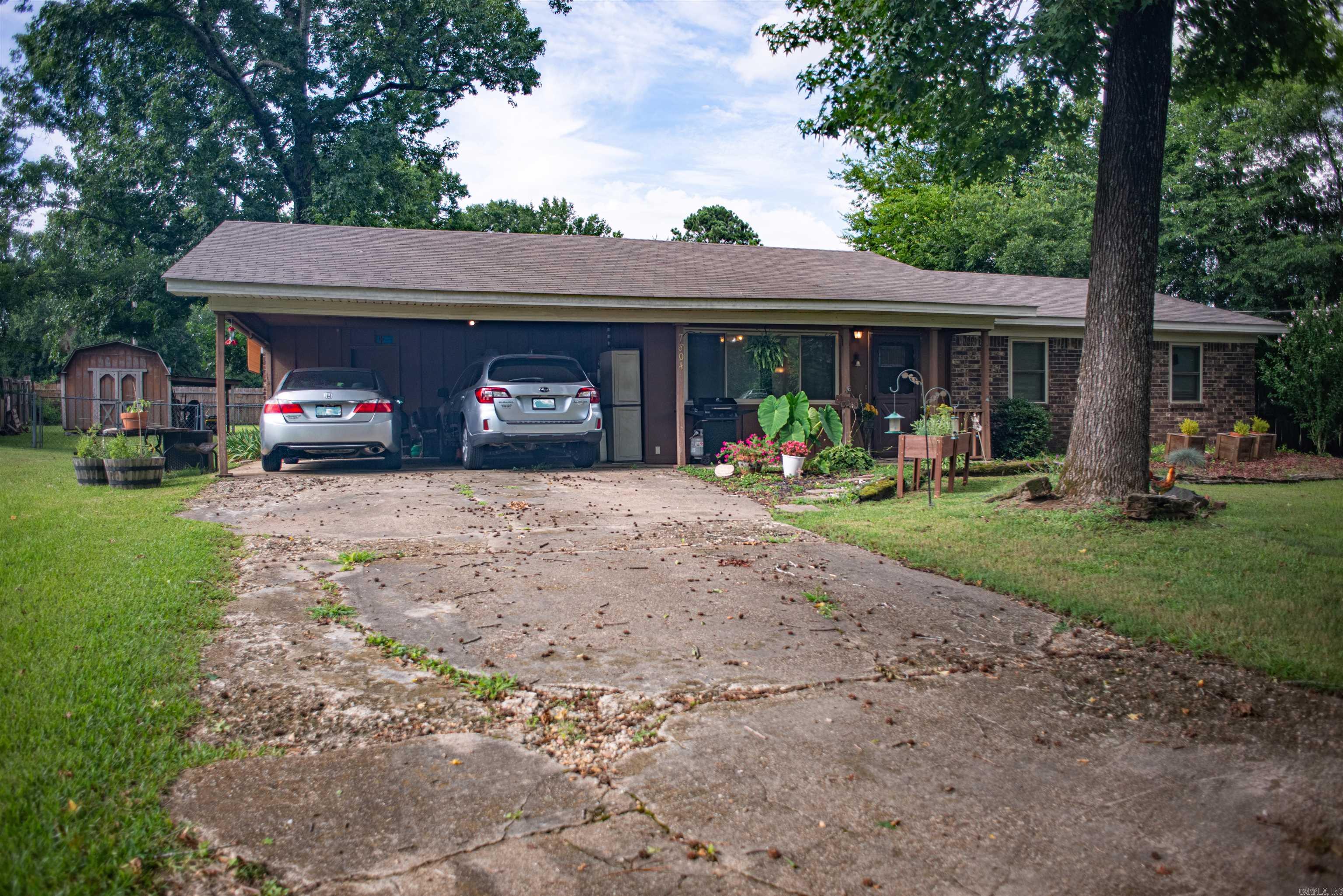 Located in a quiet neighborhood in Benton, this single-level home offers 1,290 sqft of living space. It includes a dual-parking carport with an attached storage room. The large yard provides plenty of room for outdoor entertaining, gardening, or relaxing. The home includes a large outdoor storage shed. Located just minutes from shopping, dining, schools, and I-30, this property offers peaceful living with easy access to city convenience. This home is perfect for first-time buyers and small families. The level lot is great for ease of access. Come take a look!
