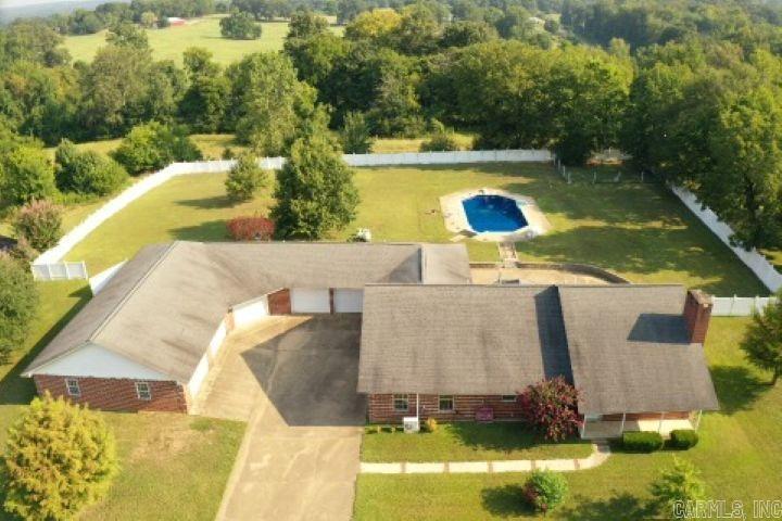 Developer's own home in one of De Queen's premier subdivisions!  Entertainer's dream with spacious rooms including five beds, four bathrooms, gigantic game room with three separate living areas, wetbar, additional washer/dryer connection, and another bonus room that would be great for an in-home theater.  Storage, counterspace, and built-ins galore throughout home.  5-car garage encompassing approximately 3K sq.ft., with six garage doors and full bathroom opening into expansive backyard with incredible patio and beautiful pool.  This is a breathtaking home ready for its next owners!
