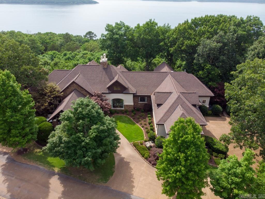 Luxurious Eden Isle FURNISHED home with incredible sunset views of Greer Ferry Lake! Built in 2002, and then completely remodeled in 2018, this exceptional home includes travertine floors inlaid with wood, marble counter tops, a very large master suite with lake view, fireplace, jet tub and walk-in shower. Viking appliances, screened porch with outdoor grill, spacious patio with great views and fireplace, bar area and wine cellar, office, 2-car garage, golf cart garage and much more! This property is in absolutely perfect condition!  5-minute golf cart ride to Eden Isle Marina!