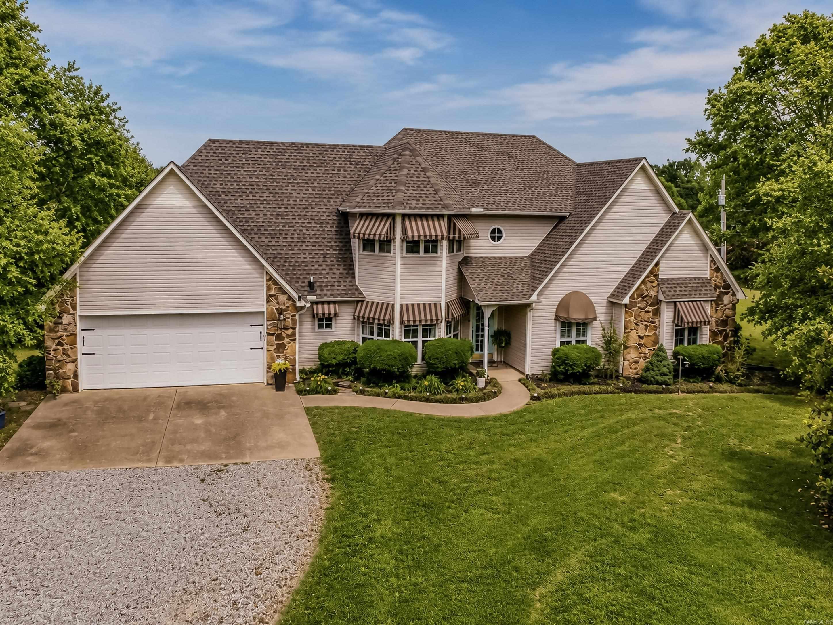 Welcome to this beautiful custom built home (2254 sq. ft.) on 10 manicured acres w/ large barn, with 5 horse stalls, wash bay, office, indoor arena, tack room. There is also an outdoor arena. There is an abundance of beautiful flowers, fruit trees, 2 types of apples, fig trees, crape myrtles, magnolia and so many more. Fenced garden, ten acres of pasture and beautiful yard. House has had exquisite attention to every detail. The master suite is beautiful while at the same time relaxing. Master bath hosts jetted tub as well as walk in shower. Abundance of storage. Your guests will be impressed with the living room, fireplace, and door to the covered patio with breath taking views of the pasture and horses. The upstairs has full bath and2 bedrooms. Call us today for a private tour.