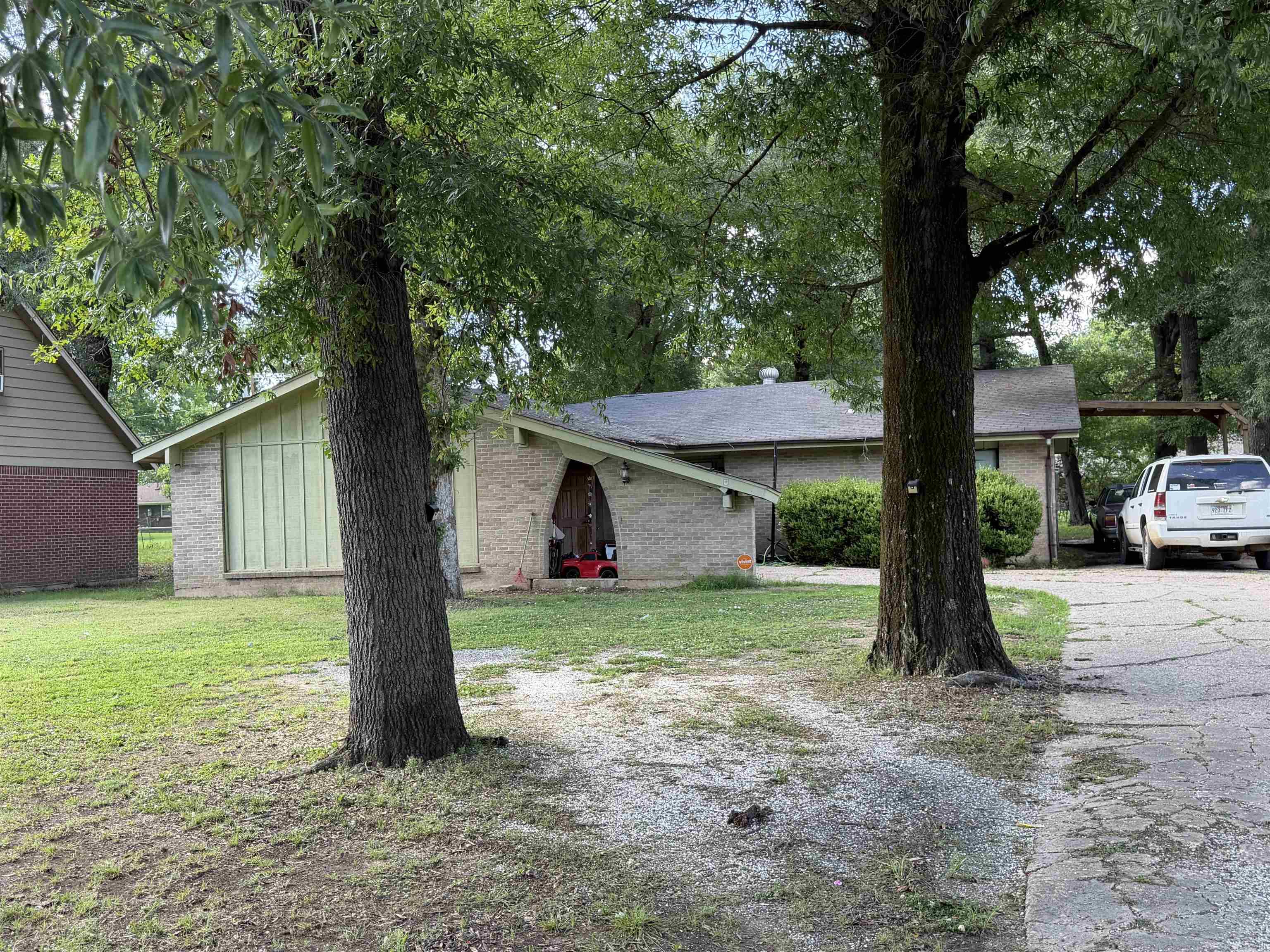 This brick home features 3 bedrooms, 2 bathrooms, and a 2-car carport. The functional U-shaped kitchen offers plenty of workspace and includes a large window above the sink with a beautiful view. Tile flooring runs throughout the home, and a versatile bonus room off the laundry area could serve as a 4th bedroom, home office, hobby room, or additional living space. New water lines are currently being installed in the area, including service to this home. Seller Disclosure: This home does have some settlement, which is common for homes in this area. Loan qualification for FHA or Rural Development (RD) financing will ultimately be determined by the appraiser and lender. The seller makes no representations or guarantees regarding FHA or RD loan approval. it will qualify for conventional.