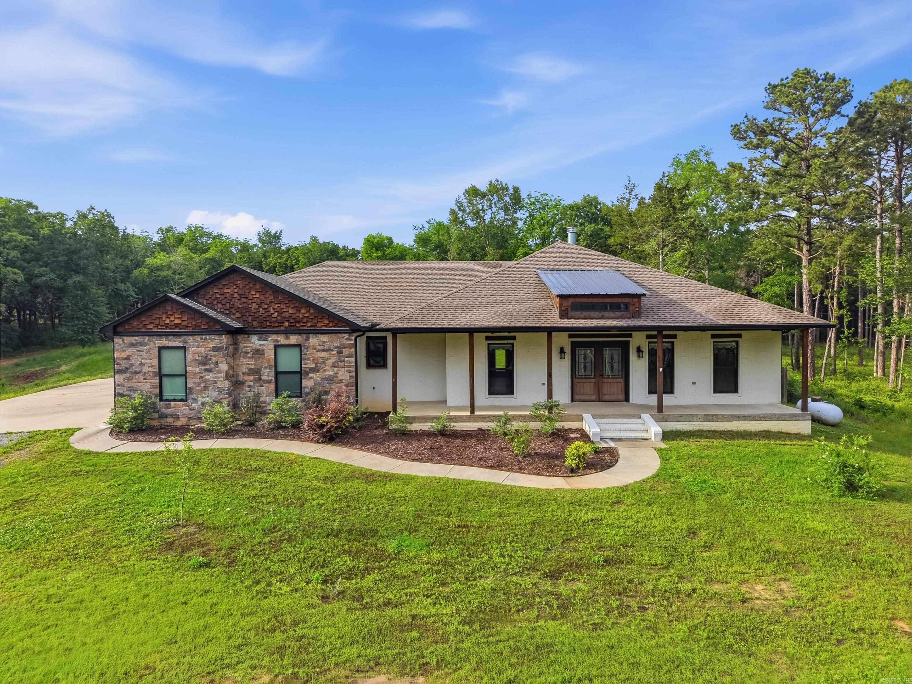 What a unique property! Situated on 2.24 acres just outside the city limits w/ two shops,including one w/ an 800 ft.² apartment.The main home features approximately 2,300 sq ft w/3 bedrooms, 2 baths & a dedicated office. A welcoming front porch leads to the spacious living area w/beautiful fireplace, opening into the dining space & stunning kitchen complete w/stainless steel appliances, copper farmhouse sink, tile backsplash, pendant lighting, large center island & walk-in pantry. The primary suite is generously sized w/spa-like bath & large walk-in tile shower, soaker tub, double sinks & spacious walk-in closet. Two additional bedrooms share a hall bath & separate office provides the perfect flex space. The 40x50 shop includes a finished apartment with 2 bedrooms, 1 bath, kitchen and living area, ideal for guests, rental income or multi-generational living. A second 30x40 shop with its own bathroom adds even more functionality for storage, business or recreational use. Enjoy the outdoors with a pond and plenty of open yard space, all just minutes from the Arkansas River and West Conway.