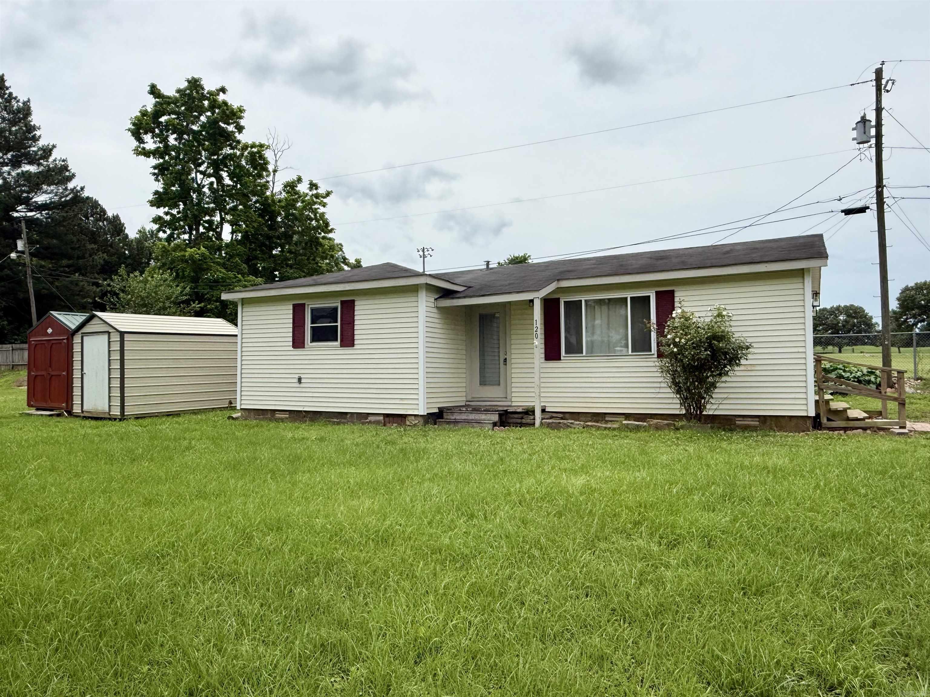 Charming 2-bedroom, 1-bath home offering 704 square feet of comfortable living space on a spacious 0.60-acre lot. Conveniently located near Lamar Schools, this property provides the perfect blend of small-town convenience and country living.  The home features a functional floor plan with plenty of potential for first-time homebuyers, those looking to downsize, or investors seeking a rental opportunity. The generous lot offers room for outdoor activities, gardening, or future improvements with 2 shop/sheds perfect for a workspace or storage!!  With its affordable size, desirable location, and investment potential, this property is a great opportunity!!!