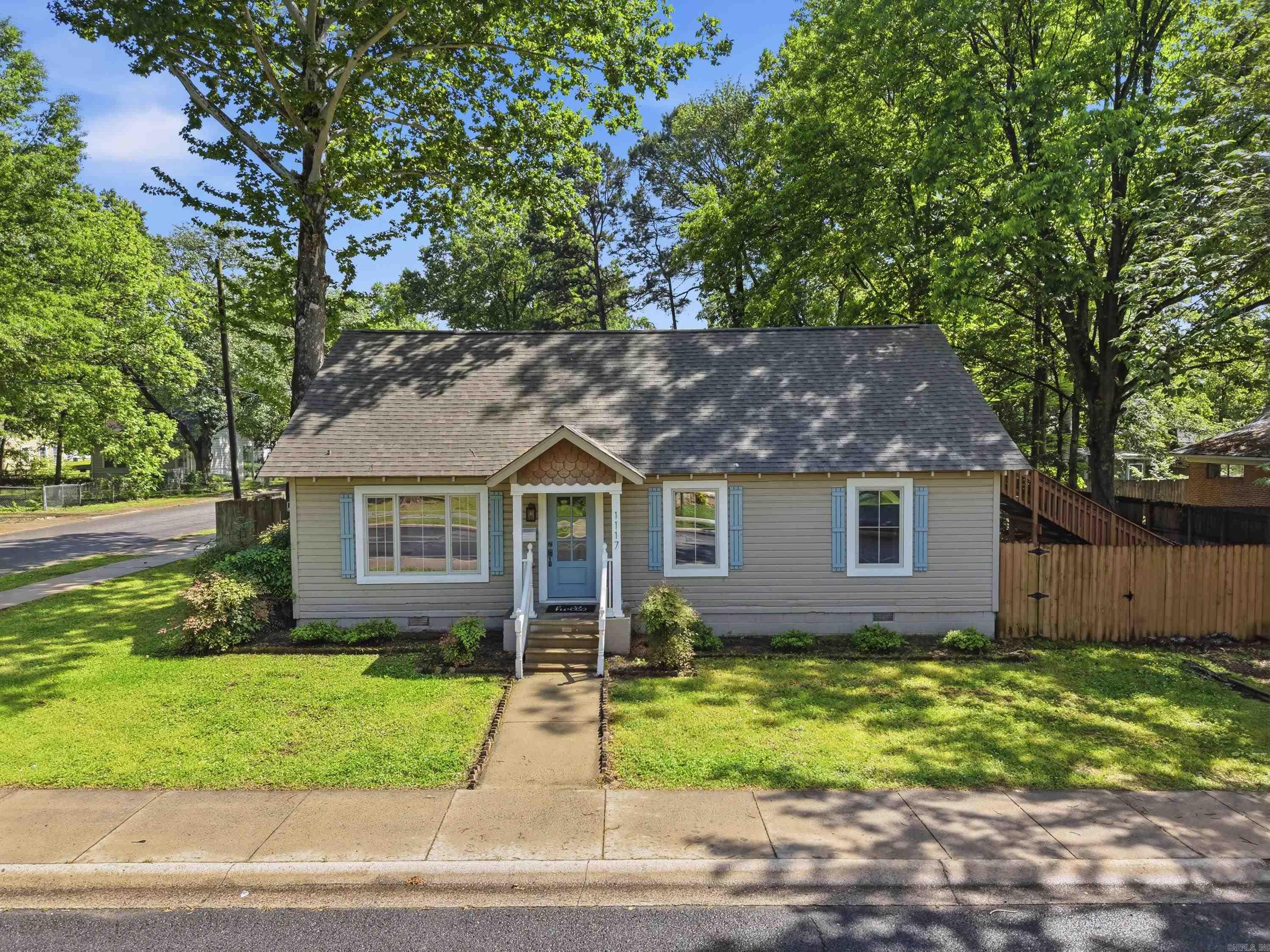 This 4-bedroom, 2-bath two-story home offers a flexible layout with 3 bedrooms on the main level and a private upstairs bedroom with its own bath and exterior entry. Many updates were completed in recent years, including updated bathrooms, kitchen countertops, some flooring, and fixtures, along with fresh paint throughout for a clean, refreshed feel. The dining area includes French doors that lead to a deck, creating a great flow for indoor and outdoor living. Situated on a corner lot, the property provides plenty of outdoor space, along with a storage building that conveys. Centrally located in Conway. Agents see remarks.