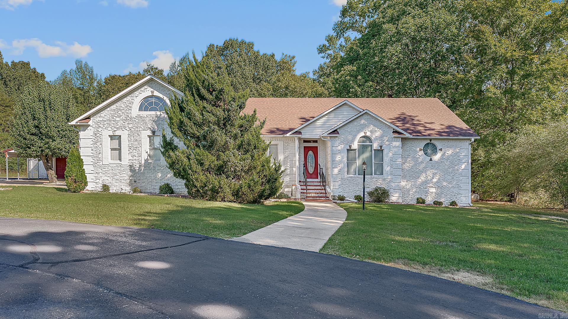 Tucked away in the heart of the city, this unique property offers privacy, space, and versatility on 1.37 acres. A private drive leads to a well-maintained home featuring an office, formal dining, and a laundry room with sink. The kitchen showcases warm Mexico brick paver floors, and the washer and dryer stay. The spacious primary suite includes direct access to the sunroom and features its own cozy fireplace, while the great room also includes a fireplace for added warmth and charm. Two guest rooms feature built-in desks. Recent updates include the roof and HVAC. Outside, enjoy two shops—one with a half bath and heated workshop—plus a circle drive for added convenience. A rare opportunity for private, in-town living! Ejnoy working on hobbies or collectibles, there are so many option here to love.