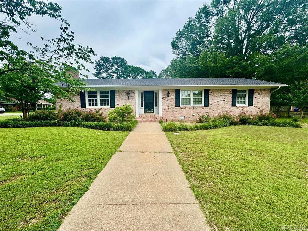 LOCATED RIGHT IN HEART OF CONWAY Great family home, makes great rental since its walking distance  to UCA and Conway Regional and has been a successful AIR BNB.  The home has two living areas one is a sunroom with lots of naturual light which would make a great art Studio  and the other has a cozy fireplace. The Floors are original, beautiful legit wood. The home sits on a rare lot that has corner lots on both ends. This home has a ton of storage inside and outside. The garage has two storate rooms in it, one is heated and cooled.There is an outside shop with elec.  The wooden deck overlooks a natural, peaceful landscaped area to help you unwind. A unusual pull through drive from Timothy to Rebecca and makes great parking for  your trailer or RV.  NEW ROOF AUGUST 2024  THERE ARE TWO HVAC units,   AGENTS SEE CONF REMARKS