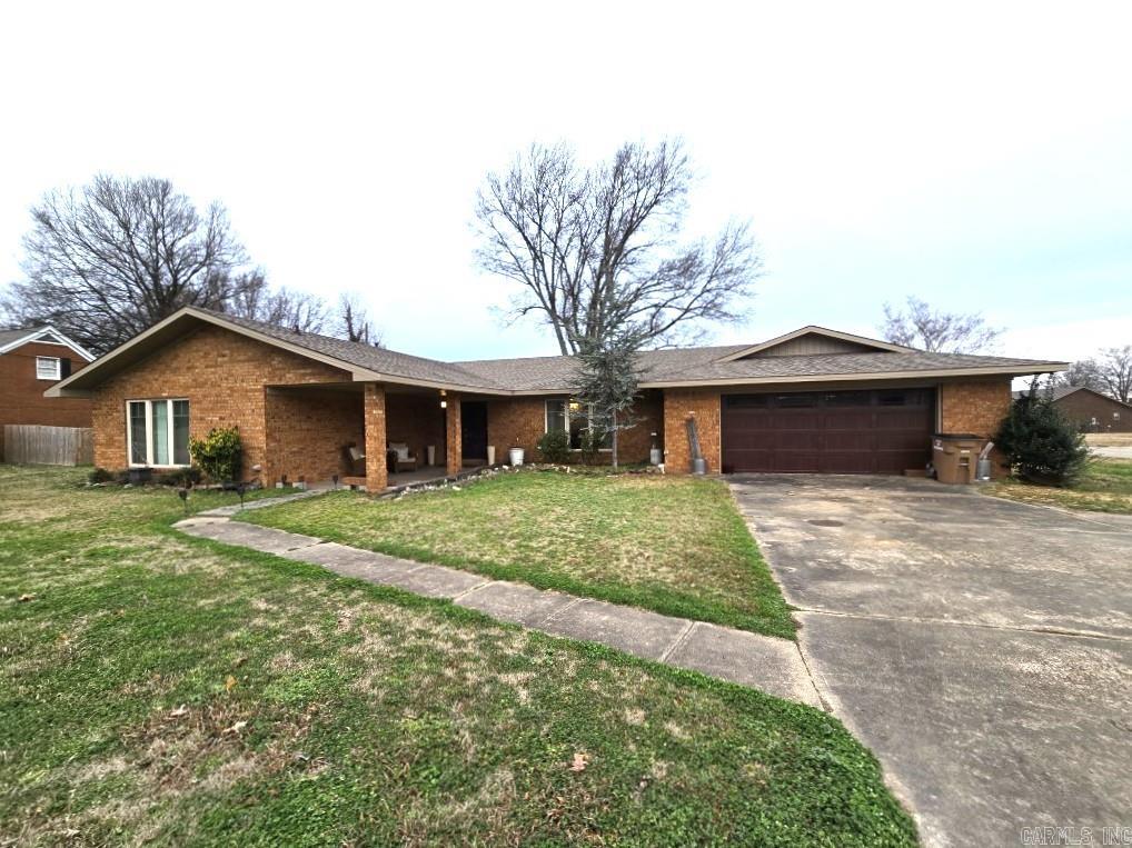 Embrace elegance and comfort in this beautifully designed 2,048 sq. ft. single-story home in the heart of Wynne, Arkansas. Blending traditional charm with modern updates, this home offers two inviting living areas ideal for relaxing or entertaining. The spacious primary suite spans approximately 260 sq. ft. and includes an en-suite bath and generous closet space, creating a private retreat.  The kitchen is a standout with distinctive blue cabinetry, ample counter space, and modern appliances—perfect for both everyday meals and special gatherings. Flexible dining areas accommodate formal or casual entertaining with ease.   A cozy fireplace anchors one living space, while a wood-paneled family room adds rustic character. Large windows throughout fill the home with natural light, creating a bright and welcoming atmosphere. Tastefully designed bathrooms offer a spa-like feel with contemporary finishes and soothing colors.  With a functional layout and timeless appeal, this home offers the perfect setting for comfortable living and lasting memories, combining small-town tranquility with modern convenience.