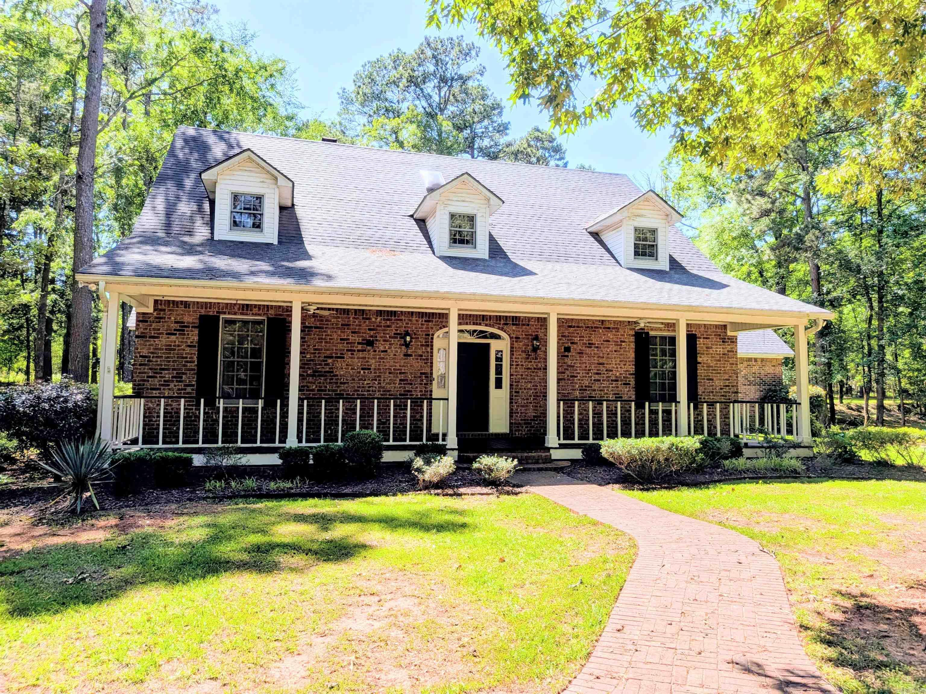 Welcome home to your own private slice of paradise! A circular drive leads you to this inviting 3BR, 2.5BA country retreat, complete w/ wooded backdrop, lush landscaping, & a welcoming front porch. Foyer w/ gleaming wood floors & an open floor plan. The family room features 2-story ceilings, custom brick fireplace, wall-to-wall bookcases, & windows overlooking the patio. The bright kitchen/dining area boasts a center island, quality appliances, & excellent storage. The formal dining room offers extra entertaining space. The primary suite is the perfect retreat w/ a walk-in closet & bath w/ 2 vanities, walk-in shower &, a large whirlpool tub. Upstairs, find 2 BRs, each w/ an attached bonus room. A full bath & balcony overlooking the family room complete the upper level. Outside, the barn is perfect for tools & ATVs, as well as a spacious double garage. The 3.6-acre lot is well-maintained, offering privacy, space, & charm in every direction. Across the street is a 6-acre parcel w/ a spring-fed pond, included for even more outdoor enjoyment. *Gas tankless water heater & vacuum system convey. Square footage, lot size, and acreage taken from courthouse records.