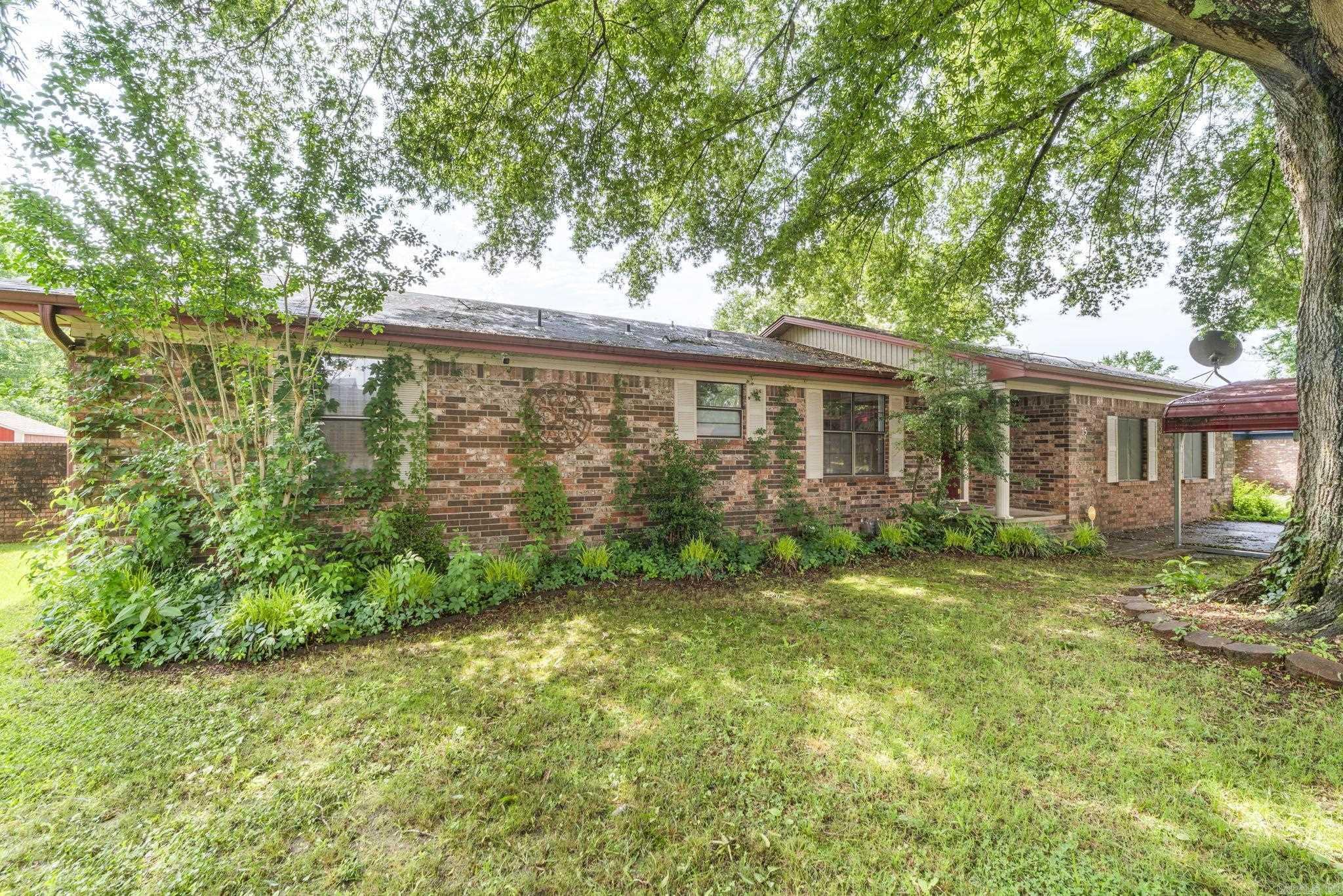 Welcome to this all-brick 3-bedroom, 2-bath home tucked away at the end of a quiet cul-de-sac! Surrounded by mature trees and backing up to peaceful green space, this property offers the perfect combination of privacy, comfort, and outdoor living. Inside you'll find two spacious living areas with a gas fireplace, hardwood floors, and a small office tucked away from the bedrooms. The spacious primary suite easily accommodates a king-sized bed and features a private en-suite bathroom along with a walk-in closet. Step outside to your own inground pool, gazebo, covered deck, workshop, and small pool house — ideal for relaxing evenings, hosting cookouts, or enjoying your private outdoor oasis year-round. Zoned for Cato Elementary and Sylvan Hills Middle, Junior High, and High School.