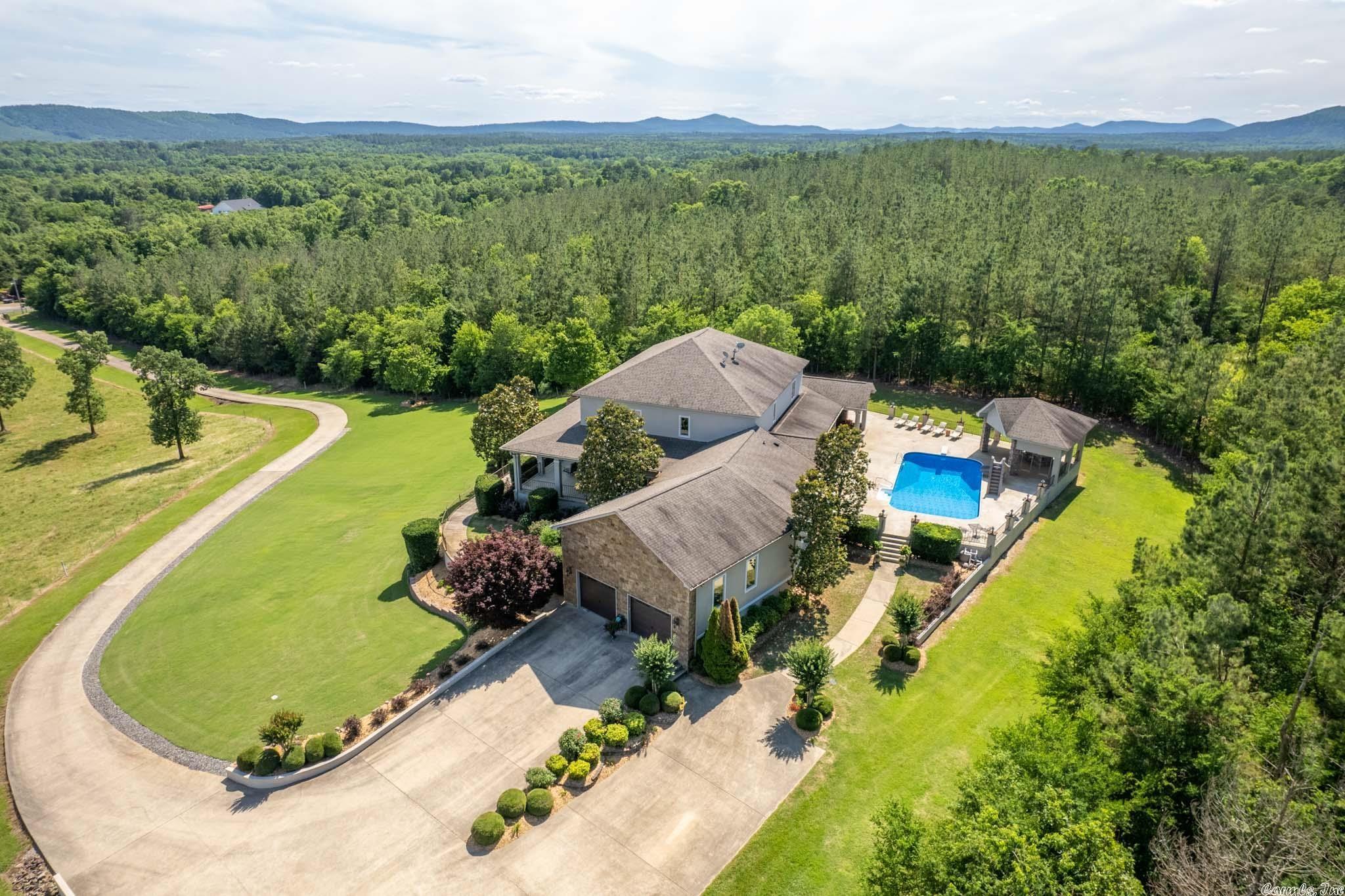 Custom home overlooking 15 acres with 30 mi southern view, Mt Riante & Fireworks seen from spacious front porches. Home has 5 bed, 3 1/2 bath, Master on main level, 4bed/2bath upper level. Outdoor party area with pool cabana, outdoor kitchen barbeque grill & more. 90' of porches for enjoying breathtaking porch views. Chiefs kitchens with gas range, ice maker, and more! The shop has exercise room with bathroom one side and storage on the other plus shed. If your looking for space, views, and privacy come on!