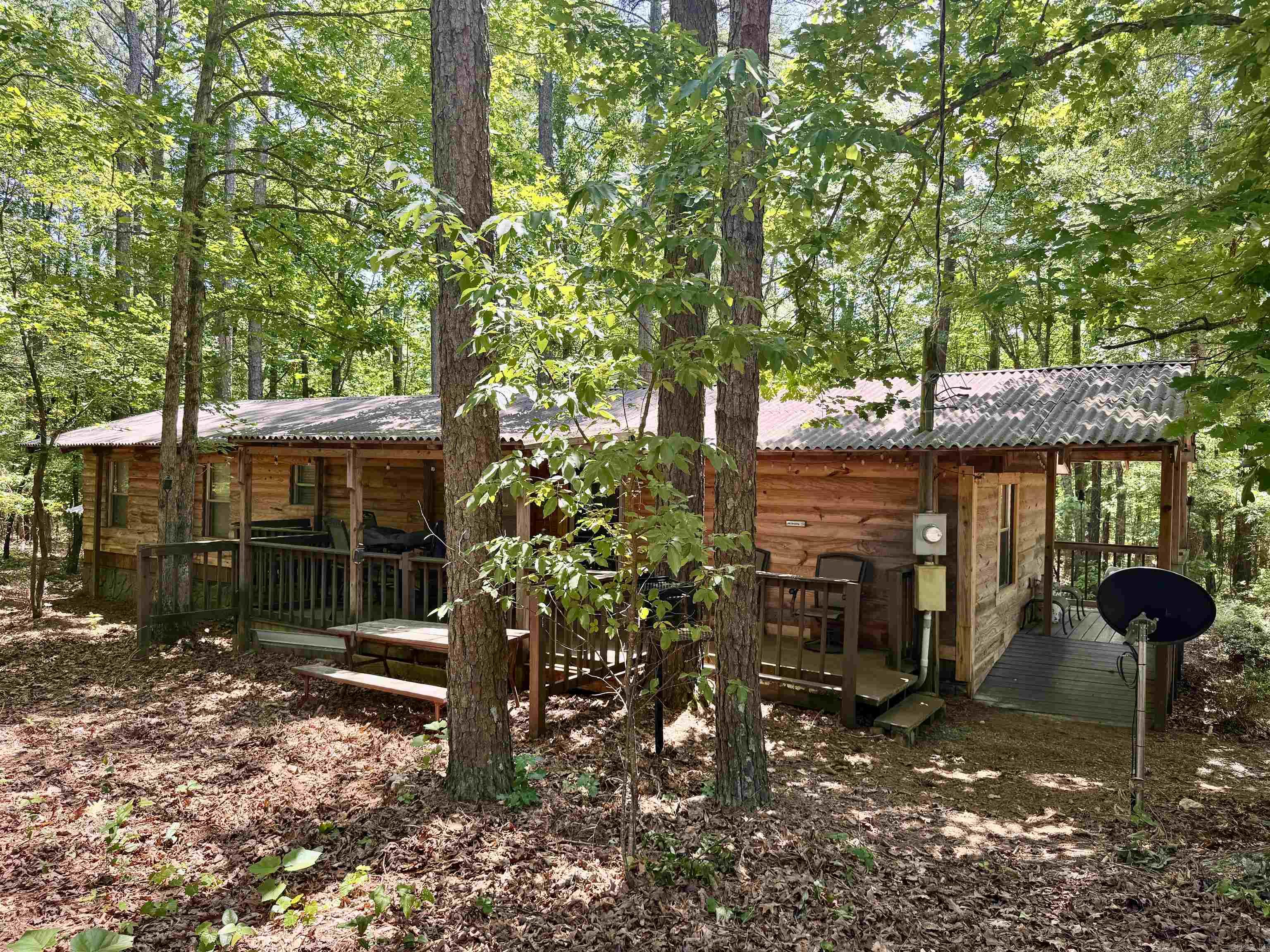 So many opportunities with these two dwellings in a beautiful natural setting. The 904 sq' mobile 3/2 home has been completely renovated inside and out. You would even know it's an MH. The 540 sq ft 1-bed 1-bath tiny home has been built to the same high-quality standards. These units have been used as short-term rentals and have a wonderful rental history.  They are being separated from Knotty & Nice cabin rentals, which all used one water source. A well will need to be installed. Seller will allow water to be used from their well for 30 days after closing to allow time to have this done. Each unit has its own septic system. Each unit has its own hot tub. Taxes will need to be figured separately from the entire complex, so the listing is not accurate there. Acreage will be adjusted on listing once the survey is completed.