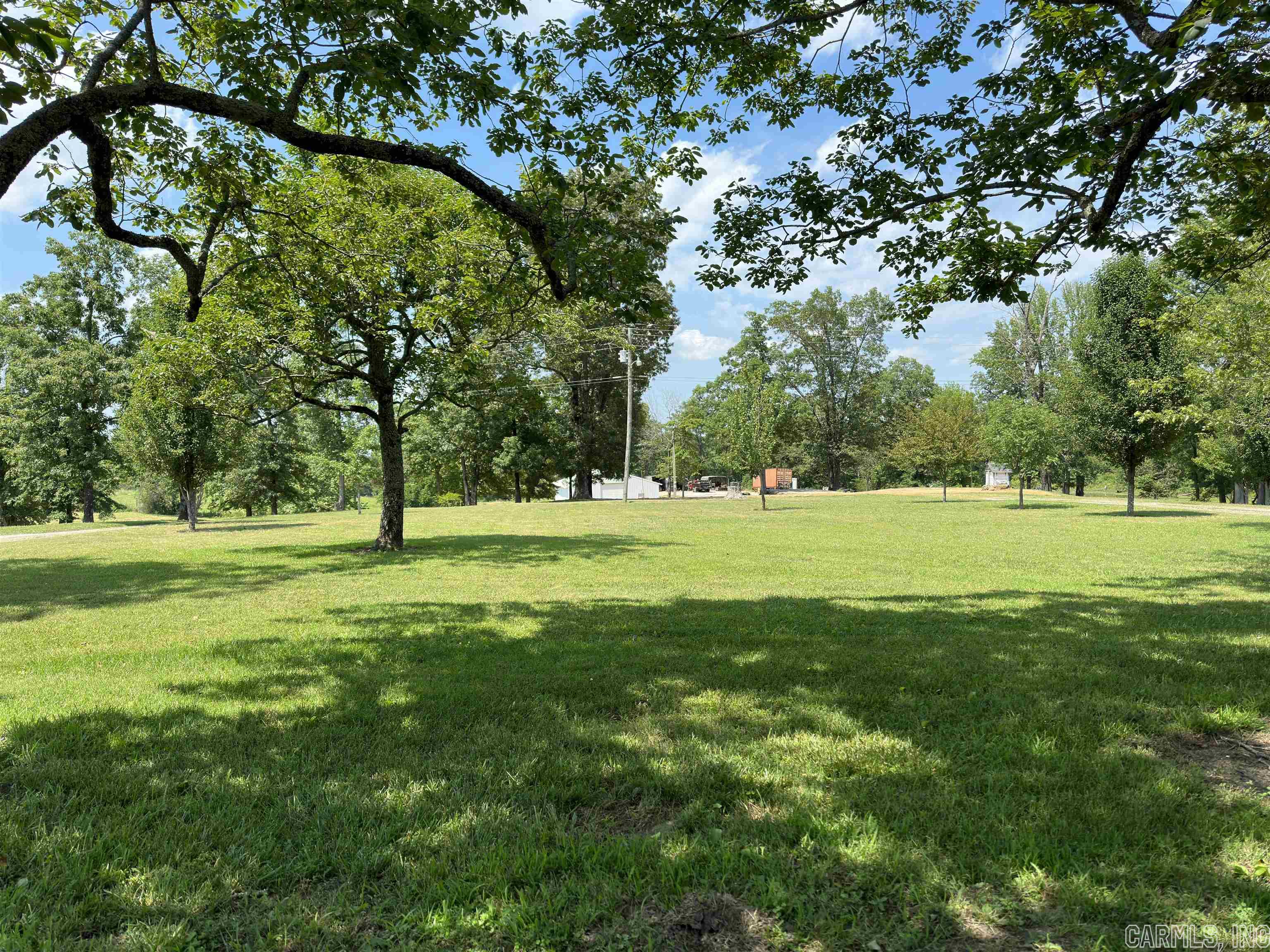 MOTIVATED SELLER!!!  You will find this property surrounded by mature trees as you enter the circle drive.  Great spot for livestock or use part of the acreage for a hay field. So many possibilities with this acreage.  You will find a 42x72 shop for all your toys or equipment, a pond and not to mention the perfect spot to build your dream home.  This property has 600’ of highway frontage and it is cleared and ready to go.  Current survey available. Call today to tour this property!