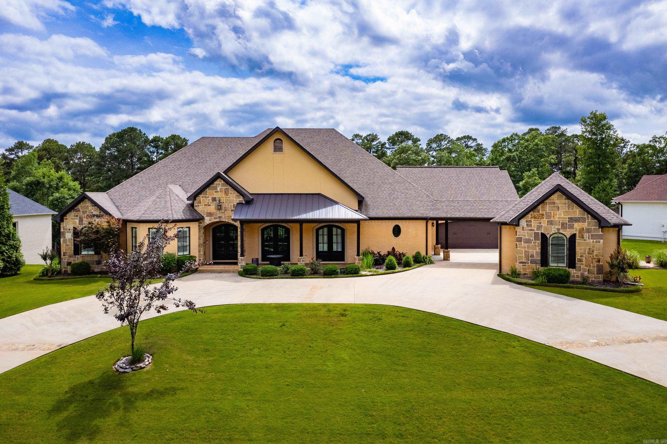 Welcome to 20 Accadia Court, a stunning turn-key estate nestled on a rare .64-acre greenbelt lot in the heart of Chenal Valley. This completely updated sanctuary blends modern luxury with ultimate privacy, featuring an open-concept layout with soaring ceilings, brand-new designer tile, and fresh interior paint. The chef’s kitchen is a showstopper, boasting dual quartz islands, custom lighting, and freshly finished cabinetry. Retreat to the main-level primary suite, complete with a spa-like bath and a built-in safe room. Car enthusiasts and hobbyists will love the rare, detached shop/garage in addition to the attached 2-car garage. Enjoy seamless indoor-outdoor living on the screened veranda with a cozy fireplace and built-in grill, all overlooking the peaceful woods. High-tech upgrades like app-controlled custom shades and a whole-home generator provide effortless comfort and peace of mind. Just minutes from premier golf and shopping, this home offers the luxury lifestyle you’ve been searching for! 5 minutes from Costco!