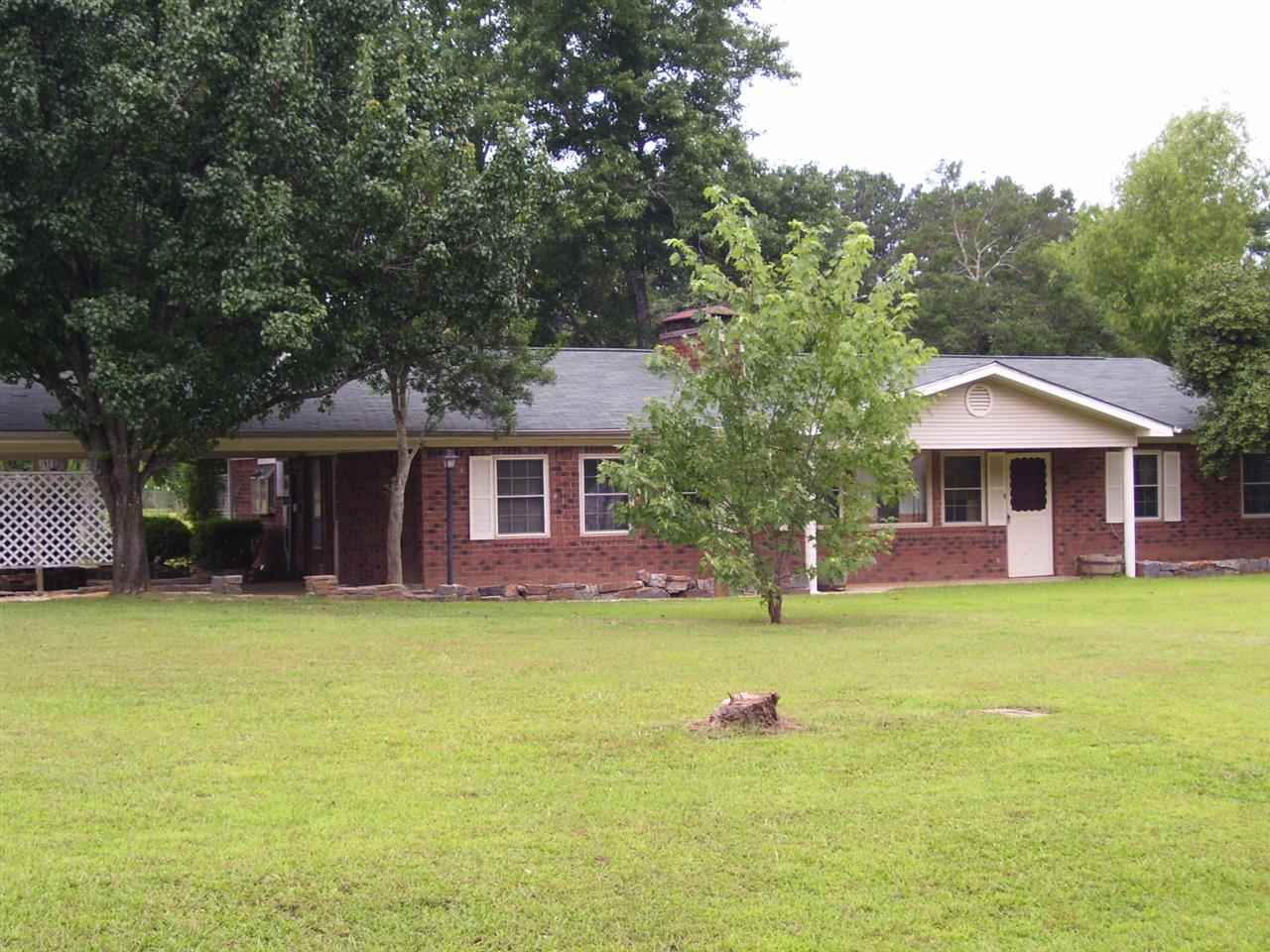 Country home on 1.52 acres. Brick home with work shop and garden spot. New carpet, laminate, vinyl flooring  paint and lots of cabinets and storage space. Shop is 20.6x28 enclosed with electricity also has a 20.6x17.6 carport to work in. has other buildings side shed is 7x19.8 going along shop.  other sheds for garden and lawn mower.  Lots of outside storage.