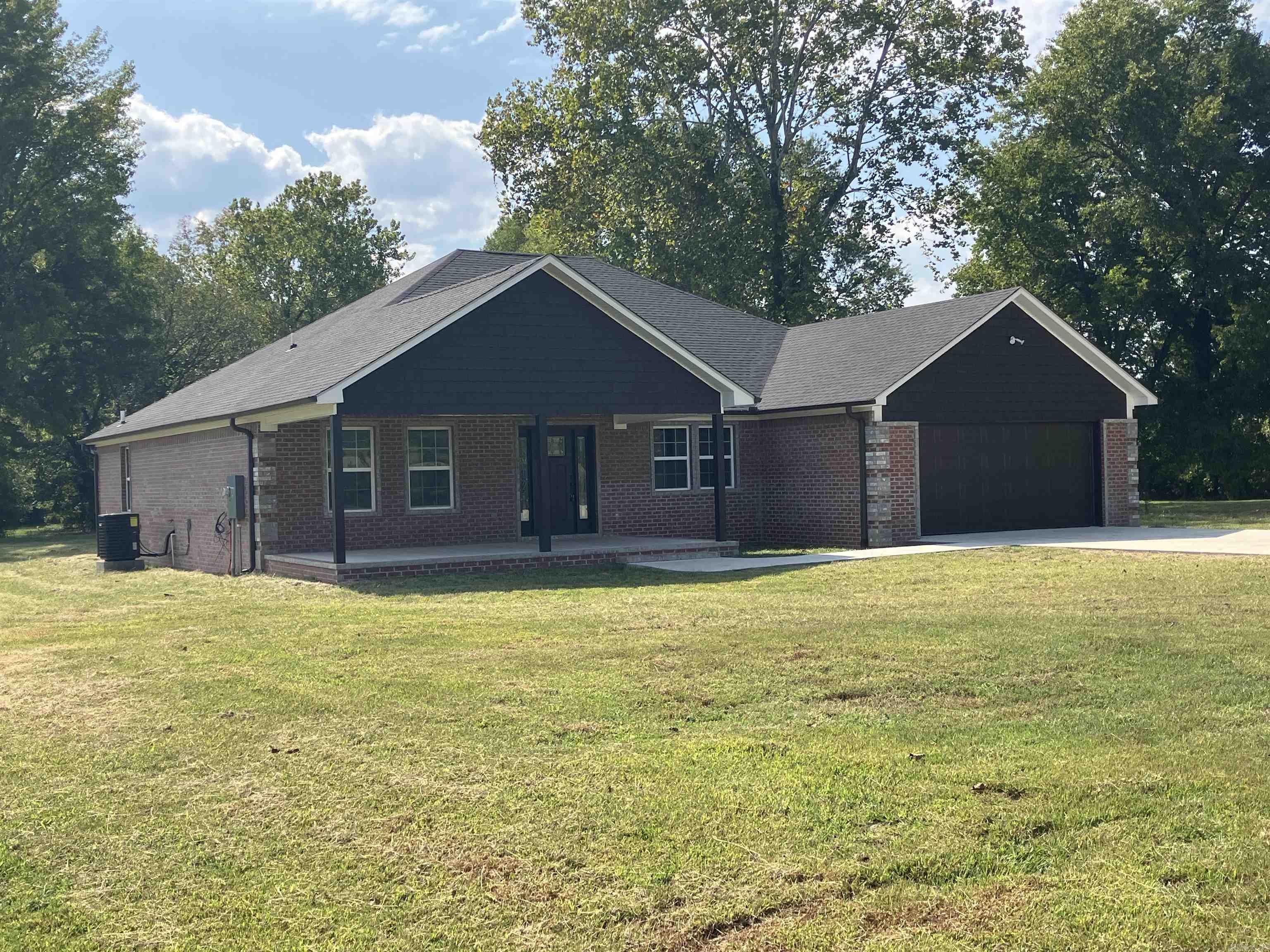 Quality & craftsmanship offered throughout this spacious new constructed dwelling on the edge of Clarksville on over 6 acres. Beautiful brick exterior w/ unique design. Large covered front & rear porches. Paved driveway. Open concept w/ spacious living/dining/kitchen areas. 4 BR’s. One located upstairs w/ access to the attic which includes over 120 sq.ft of storage space. The master includes a tray ceiling, walk-in closet, & custom tiled shower. Oversized laundry. Laminated wood floors. The home will be completed prior to closing. Kitchen in progress.