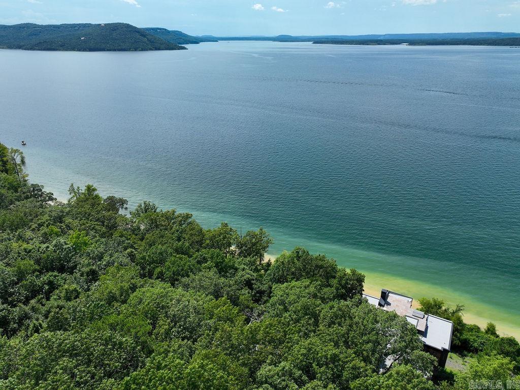 Premier Lakefront Estate on Eden Isle Nestled on the most coveted lot in Cleburne County’s prestigious Eden Isle community, this exceptional property offers unrivaled lake views from both the main residence and the charming guest house. Designed for comfort and elegance, the spacious main home features expansive windows that frame Greers Ferry Lake like a living masterpiece. The guest house provides privacy and flexibility—ideal for hosting friends, extended family, or even generating rental income.  Whether you're enjoying sunrise coffee on the deck or sunset gatherings by the water, this property delivers a lifestyle of serenity and sophistication in one of Arkansas’ most exclusive lakefront enclaves.
