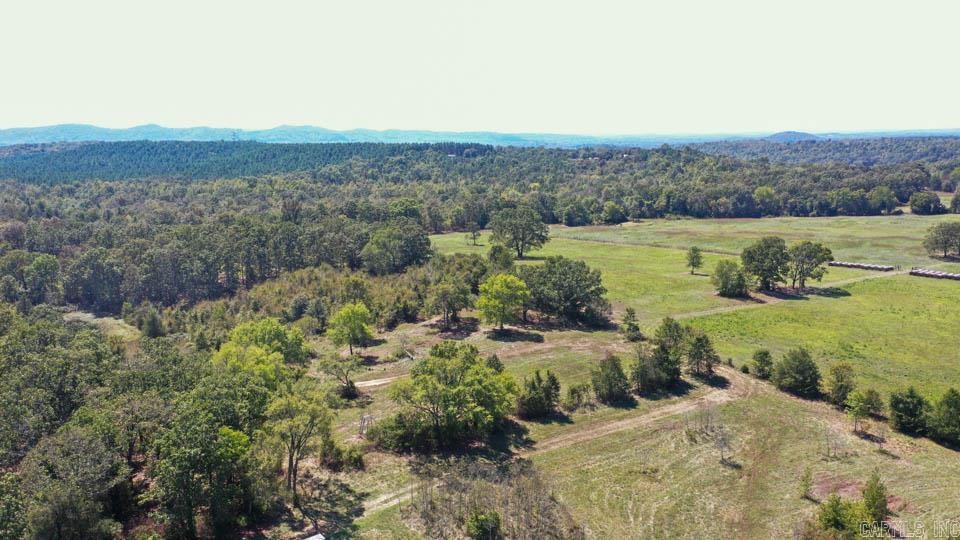 Nestled in the breathtaking Ouachita Mountains, this 60.90+/- acre tract offers the perfect blend of natural beauty, privacy, and usability. The property features a mix of partially cleared land and towering mature timber, creating an ideal setting for recreation, a homesite, or a private retreat. Access is being enhanced with a newly surveyed 40-foot road frontage from Stoney Point Road, ensuring convenient entry while maintaining seclusion. Along the entire eastern boundary, year-round Bolen Creek provides a serene water feature perfect for relaxing, exploring, or even discovering your own private swimming hole. A pond on the property offers additional enjoyment, whether for fishing or simply unwinding during the evenings. Located less than one mile from the Ouachita National Forest, you’ll have immediate access to thousands of acres of public land for hiking, hunting, and outdoor adventure. Whether you’re looking to build your dream home, create a weekend getaway, or embrace a more self-sufficient lifestyle, this property delivers. With fertile ground, fresh water sources, and level areas suitable for gardening or homesteading, the possibilities are truly endless. SEE DOCUMENTS