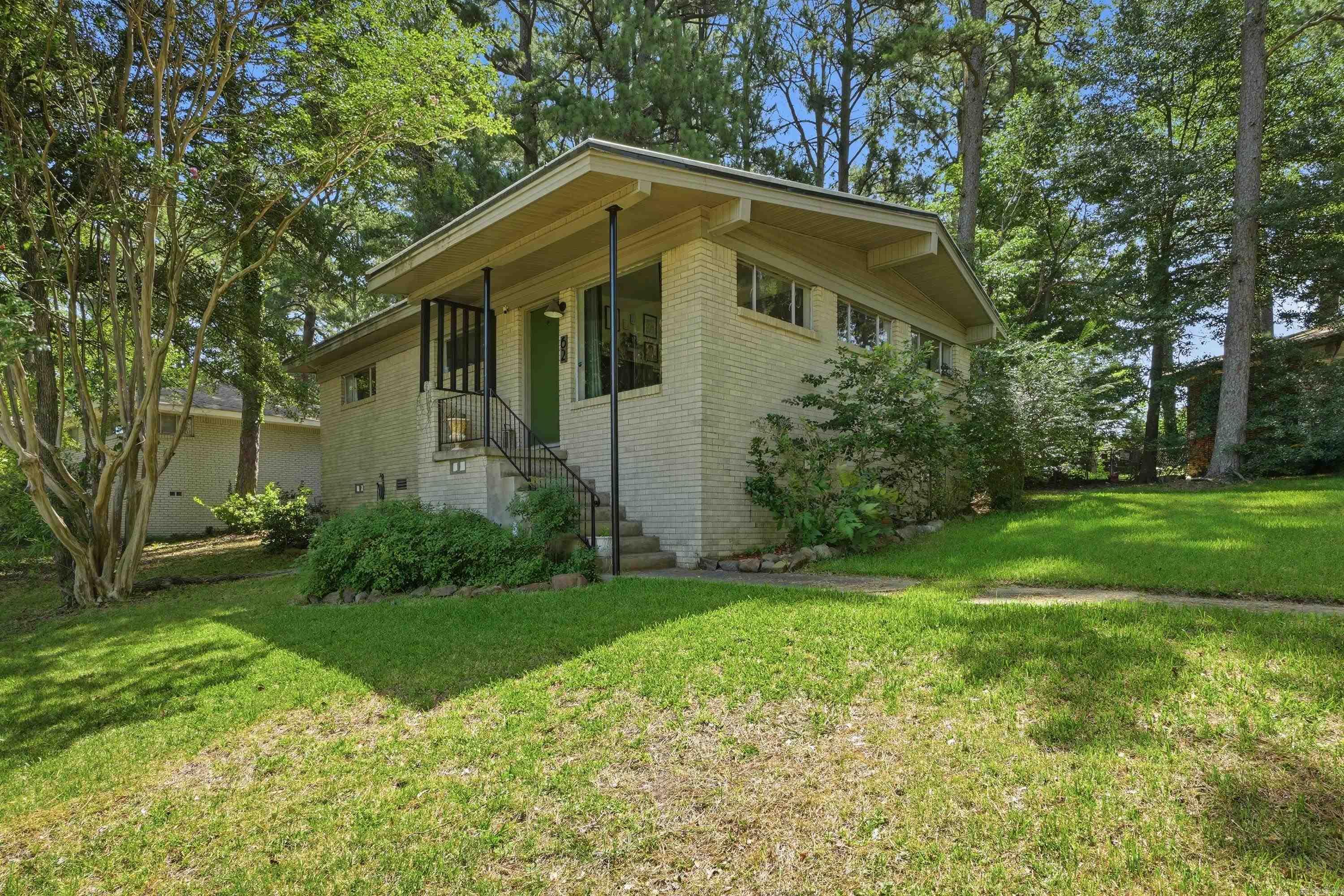 Located on a spacious corner lot in the desirable Broadmoor neighborhood, this beautifully updated home offers an unbeatable central location just minutes from UAMS, Downtown Little Rock, and Midtown shopping and dining. The updated kitchen features stainless steel appliances, granite countertops, a contemporary tile backsplash, and stylish floating shelves. Vaulted ceilings and expansive windows create a bright, open feel in the main living and dining areas. A generously sized second living area provides additional flexible living space and offers direct access to the backyard, making it perfect for entertaining, a playroom, or a home office.