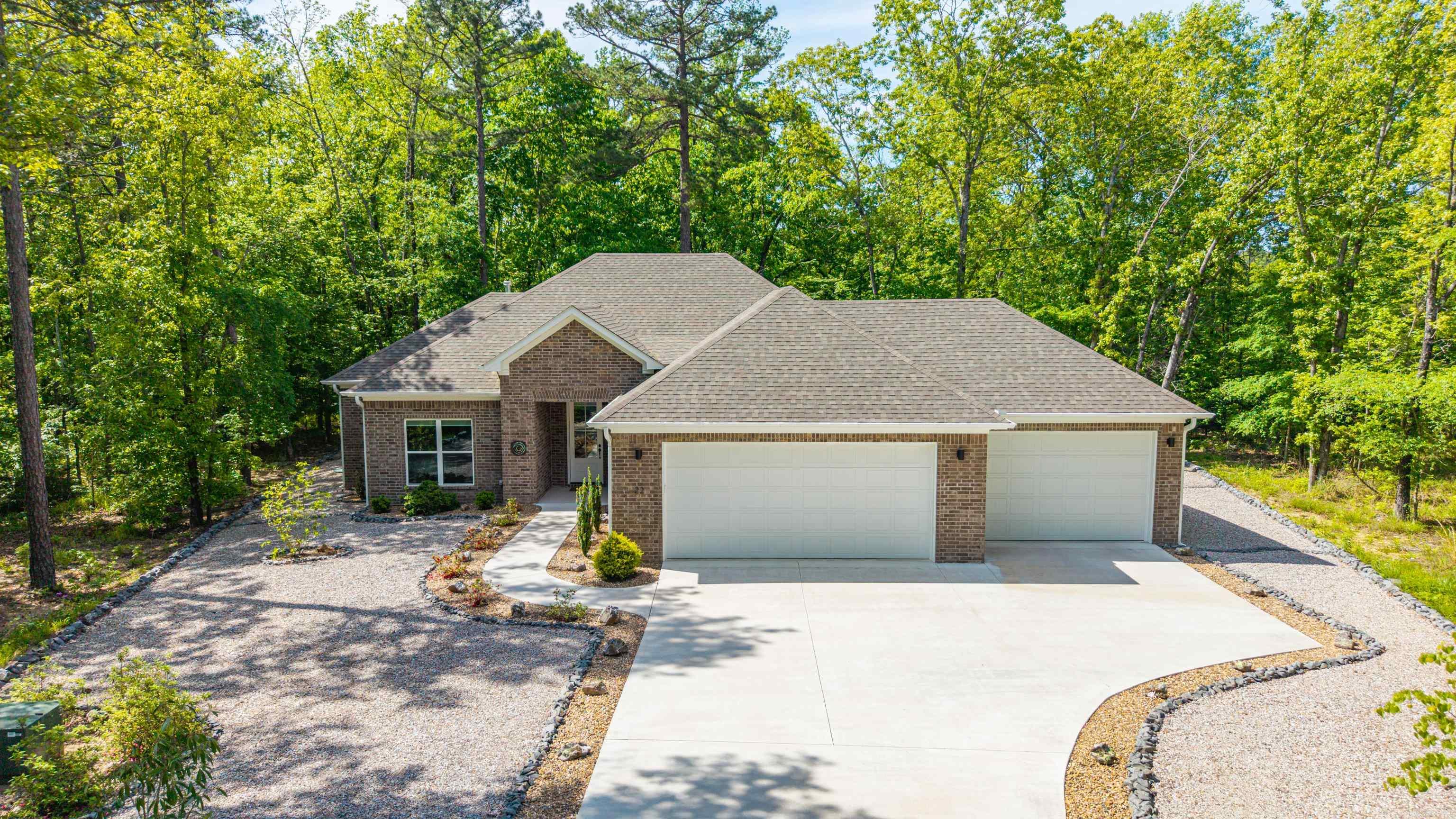Tucked just around the corner from the Glazypeau Gate in Hot Springs Village, this beautifully crafted 2024 home offers the perfect blend of quality, comfort, and convenience. Featuring 3 bedrooms and 2 baths, thoughtfully designed layout showcases impeccable attention to detail throughout. Step inside to find no carpet anywhere, complemented by gorgeous stain-grade cabinetry that adds warmth and sophistication to every space. The home has been immaculately maintained and still feels brand new. Car enthusiasts and hobbyists will appreciate the oversized 3-car garage, offering plenty of room for vehicles, storage, or a workshop. Out back, unwind in the screened-in porch. There is easy maintenance landscaping, drought tolerant plants and a leaf guard system, making it easy to enjoy the outdoors year-round with minimal upkeep. Located in one of the most convenient areas of the Village, this home combines modern construction, high-end finishes, and low-maintenance living—all just minutes from the gate for easy access in and out. Minutes away from shopping and Highway 7. Move-in ready and built to impress—this one checks all of the boxes! Full list of upgrades available upon request.