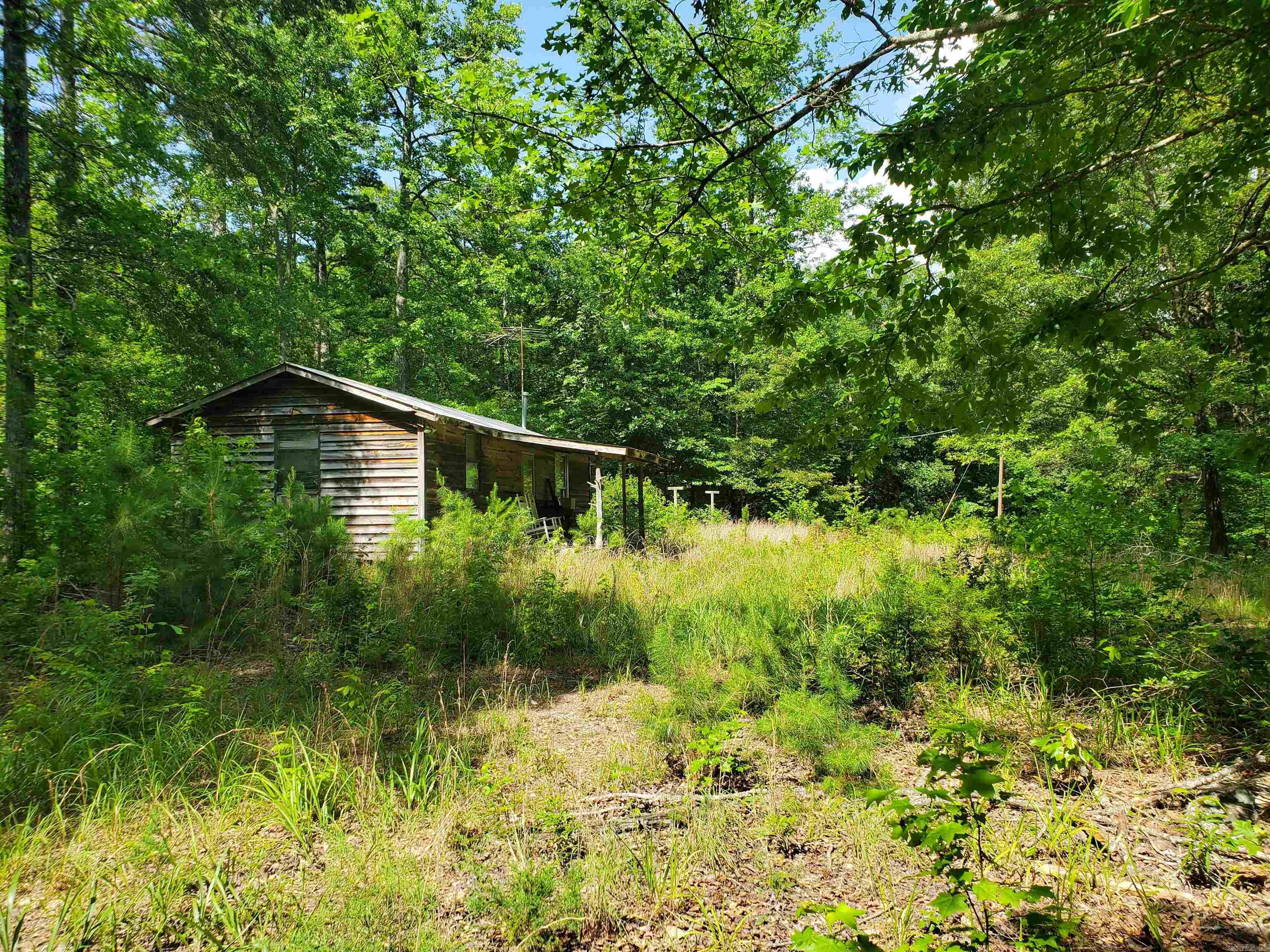 Approximately 64 wooded acres with county road frontage, offering a mix of trees, a pond, and a secluded setting with convenient access. The property is near area 4-wheeling/ATV trail systems and within a short drive of the Ouachita River, which may provide options for fishing, paddling, and other recreation, subject to buyer verification of access and any use restrictions. On-site features reportedly include a pond that attracts local wildlife, an older water well of unknown condition, and an older shed or storage structure that could be used for equipment or future improvements. This tract may work well as a recreational, hunting, or potential cabin site; buyers should verify acreage, utilities, access, well condition, and all intended uses with the appropriate authorities