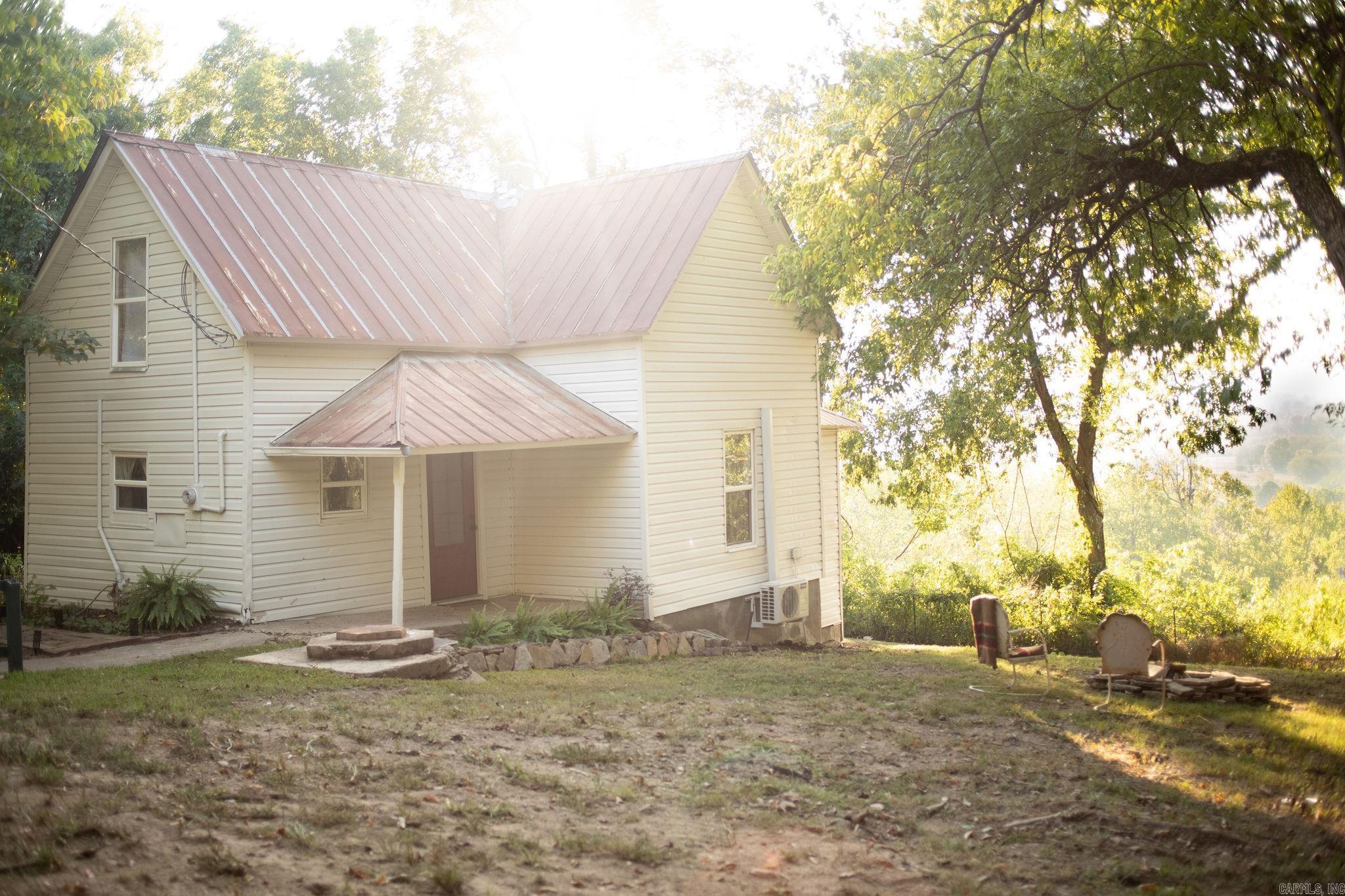 Charming 100-year-old farmhouse in down town Leslie, yet tucked away in a country setting on a dead-end street. Enjoy breathtaking mountain views from this cozy home. Just a short stroll from Skylark Cafe, Ryan's, and Serenity Farm. Experience the perfect blend of old-world charm and modern comforts in this approximately 760 sq ft gem, situated on two lots.  This is an active AIRBNB and comes fully furnished with everything you see! All you have to do is sit back and start making money or enjoy this place all to yourself!