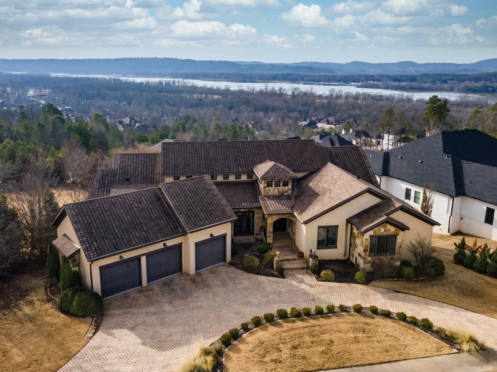 Incredible family home on a half an acre with stunning views of the Arkansas River! This custom-built home offers timeless architecture w/ luxury high-end finishes & features throughout. Two-story foyer opens to formal dining room featuring a coffered ceiling. Gourmet chef's kitchen opens to the breakfast room & great room offering a Sub-Zero fridge, Wolf range & double ovens, microwave drawer, 2 dishwashers, ice machine, wine fridge, substantial island & walk-in pantry. Magnificent primary suite offers access to covered porch & boasts a spacious bathroom w/ steam shower, soak tub, his & hers vanities & closets w/ a shared laundry room. Two additional bedrooms w/ en-suite bathrooms are on the main level. Downstairs features a large game room w/ full kitchen, 3 bedrooms, 2.5 bathrooms. Incredible outdoor entertaining space with patios surrounding the gunite pool w/waterfall & pergola. Highend features include: an elevator, Control 4 home automation system, Hickory hardwood floors & tile throughout (no carpet), foam insulation, Geothermal heating & air, Andersen casement windows & 8ft doors, central vacuum, two laundry rooms (upper & lower), mudroom, circle driveway & 3 car garage.