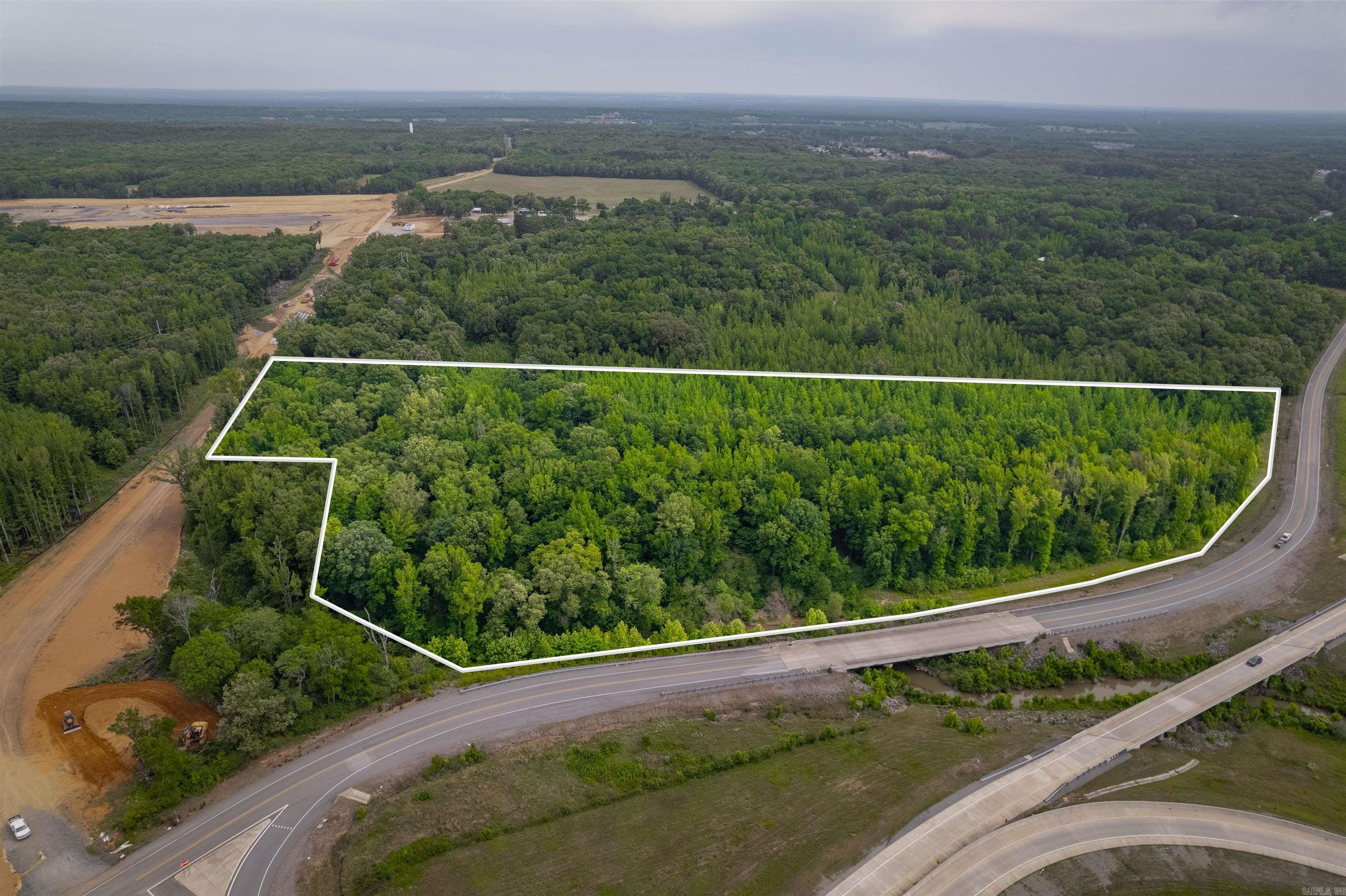 Location, Location, Location. This property has the location! Located primarily along N. Willie Ray Dr, this approx 13-Acre property has excellent marketing potential for signage and/or building commercial structures such as Hotels, Gas Stations, etc...Utilities located at roads.  The property has great long-term potential.  This property will be located on a very busy road in the near future, that will provide service extending towards Cabot's Greystone, Austin's George's Crossing & Valley View subdivisions in Austin and more!  This property has significant potential for an investor to turn this into a positive income producing property!  The sketch shown here is not a Survey.  An official Legal Description, Acreage and Dimensions shall be defined by a New Survey.   SEE AGENT REMARKS.