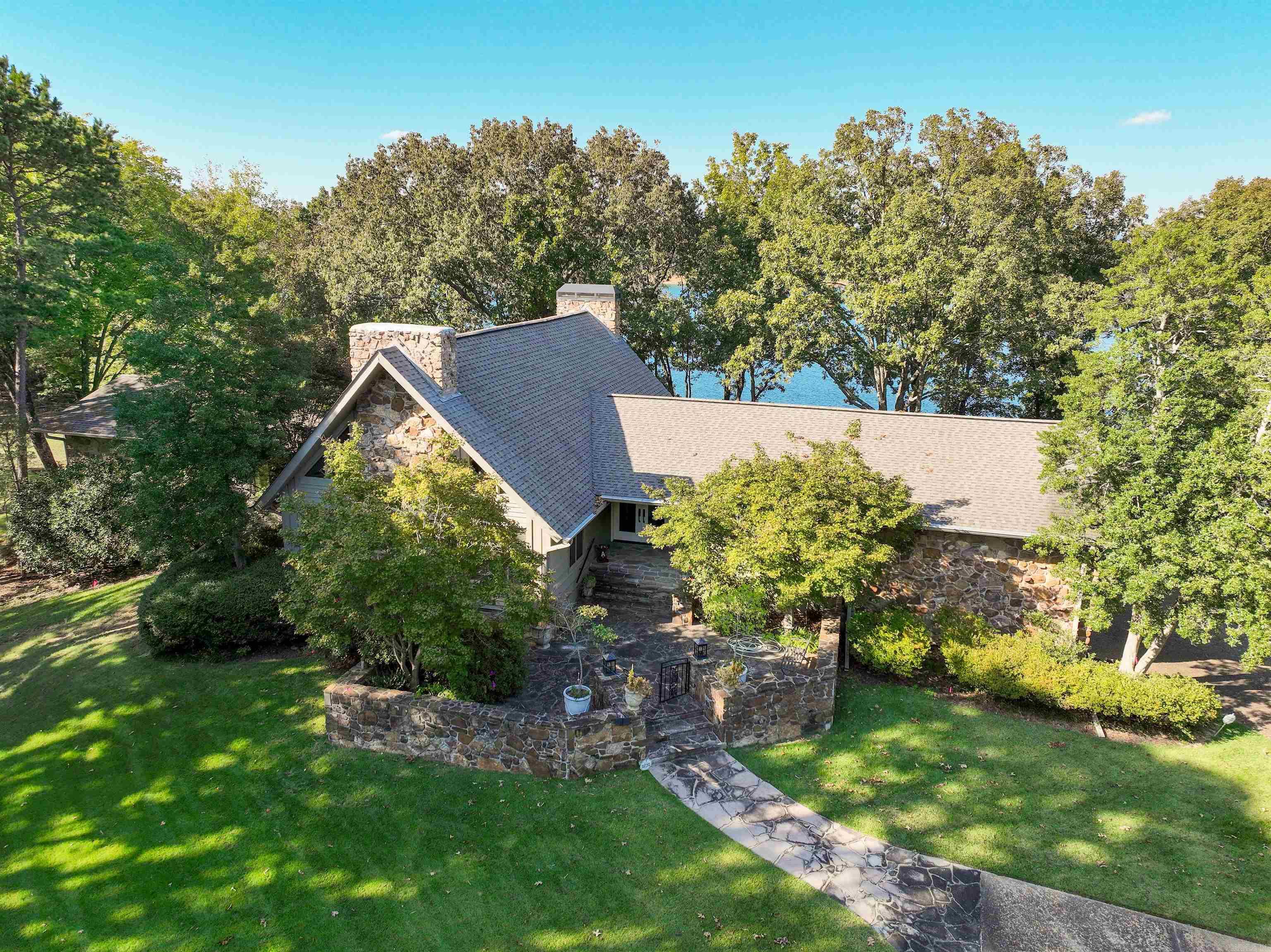 Heber Springs mostly furnished LAKEFRONT HOME on 2.25 acres!  With the lake on two side of your lot, this home is located in one of the very nicest subdivisions in Heber!  Great views of Greers Ferry Lake to the north, shaded nicely in the afternoons!  Large living area with cathedral ceilings, 3 bedrooms on the main level including the primary suite with sitting area and updated bath!  Upstairs is a spacious loft bedroom (5th bedroom) and downstairs is a wonderful family room (with pool table) and another large bedroom and bath.  Kitchen with eat-in dining, separate formal dining and breakfast bar.  Laundry has sink, W&D, large refrigerator and full-sized wine cooler.  Ample storage in walk-out basement, 2-car garage, beautiful deck and stone patio overlooking Greers Ferry Lake!  3 fireplaces, easy walk to the water!  5 minutes from Heber Springs Marina!!!  The perfect "family home"!!!  New roof in 2016, new roll out canopy about 2024!