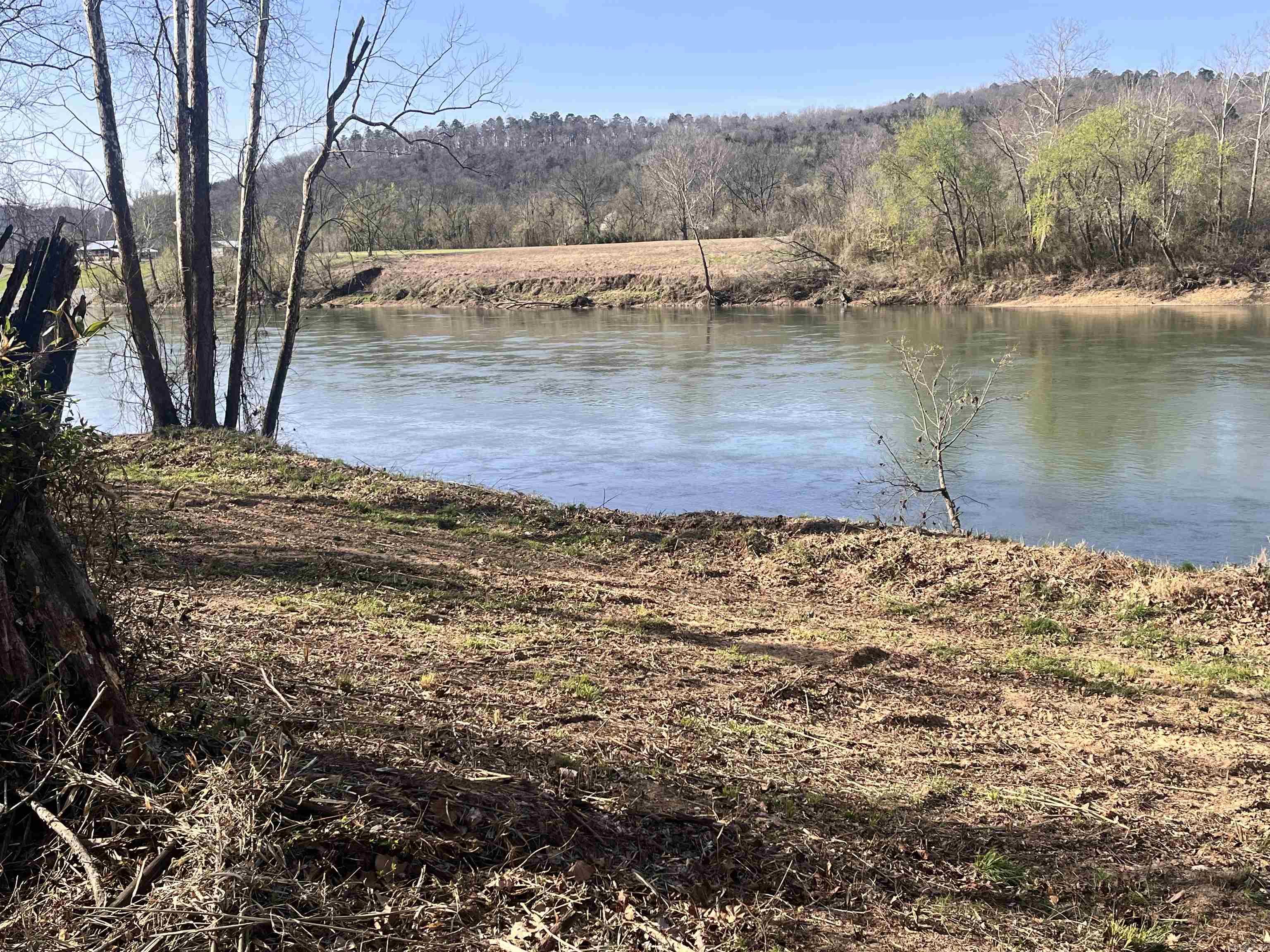 Dreaming of Living or owning a retreat on the White River? Here’s your chance to make it happen! This beautiful 1.27-acre property in Mount Olive offers 300 feet of White River frontage, with elevated River views. Step out your door to trout fish or take a drive (just a few hundred feet) to the community boat launch. No need to invest in an RV: this lot already includes a 2022, 36’ CrossRoads Cruiser that’s fully set up and ready to enjoy. The 1 & 1/2 Bath RV sleeps 8, with bunk room, features an outdoor kitchen, two A/C units, an electric fireplace, and a secure RV cover bolted down to handle the wind. All utilities are in place: well, electricity, and septic. Telephone service is available, but WiFi works great if you prefer to stay connected that way. Inside, you’ll find: Electric fireplace, Full kitchen, Two recliners, Sofa that opens into a full-size bed with a bamboo mattress, 2 A/C and gas furnace for heating, Three slide-outs with convenient switches, Electric or gas water heater, Hitch included. Both propane bottles are full, Two grey/black water tanks and a 50-gallon potable water tank, Brand-new upgraded tires(only 435 miles on them)(Property can be sold without RV)