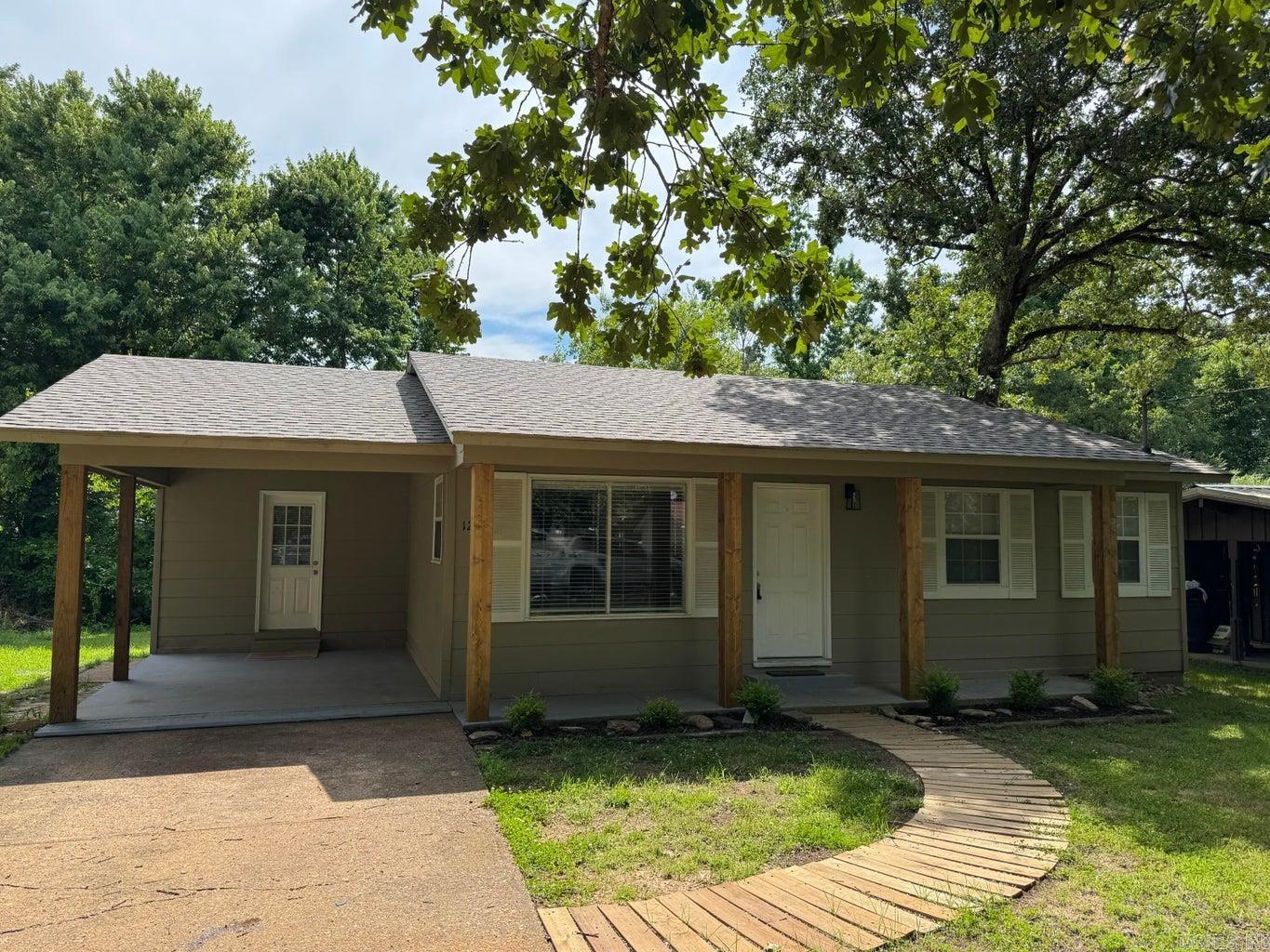 Super cute and nicely updated 2 bedroom 1.5 bath home. The curb appeal on this house welcomes you right into the open floor plan living room and kitchen. Home features a dedicated laundry and half bath, along with good storage. Extra storage or workshop attached to back of home. Check out the new wood flooring that gives the space a modern look! New roof in 2025 for peace of mind!