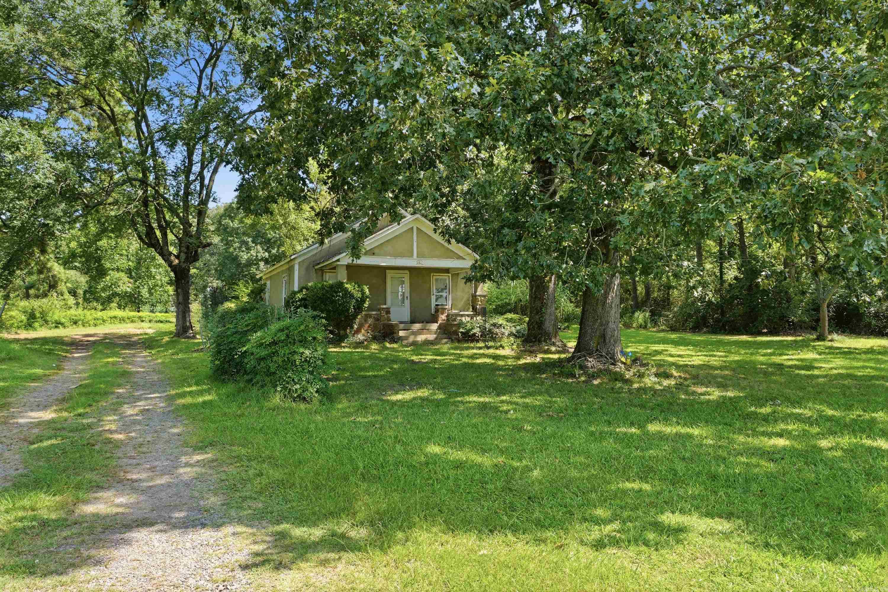 Looking for country living in the heart of town or for an investment property to build multiple home sites? This one's for you! With nearly 9.5 acres, your options are endless. The current home is being used as a rental property and will be sold "as-is" with no repairs. This beautiful property has several mature trees and has easy access to the interstate, local shopping, and schools.