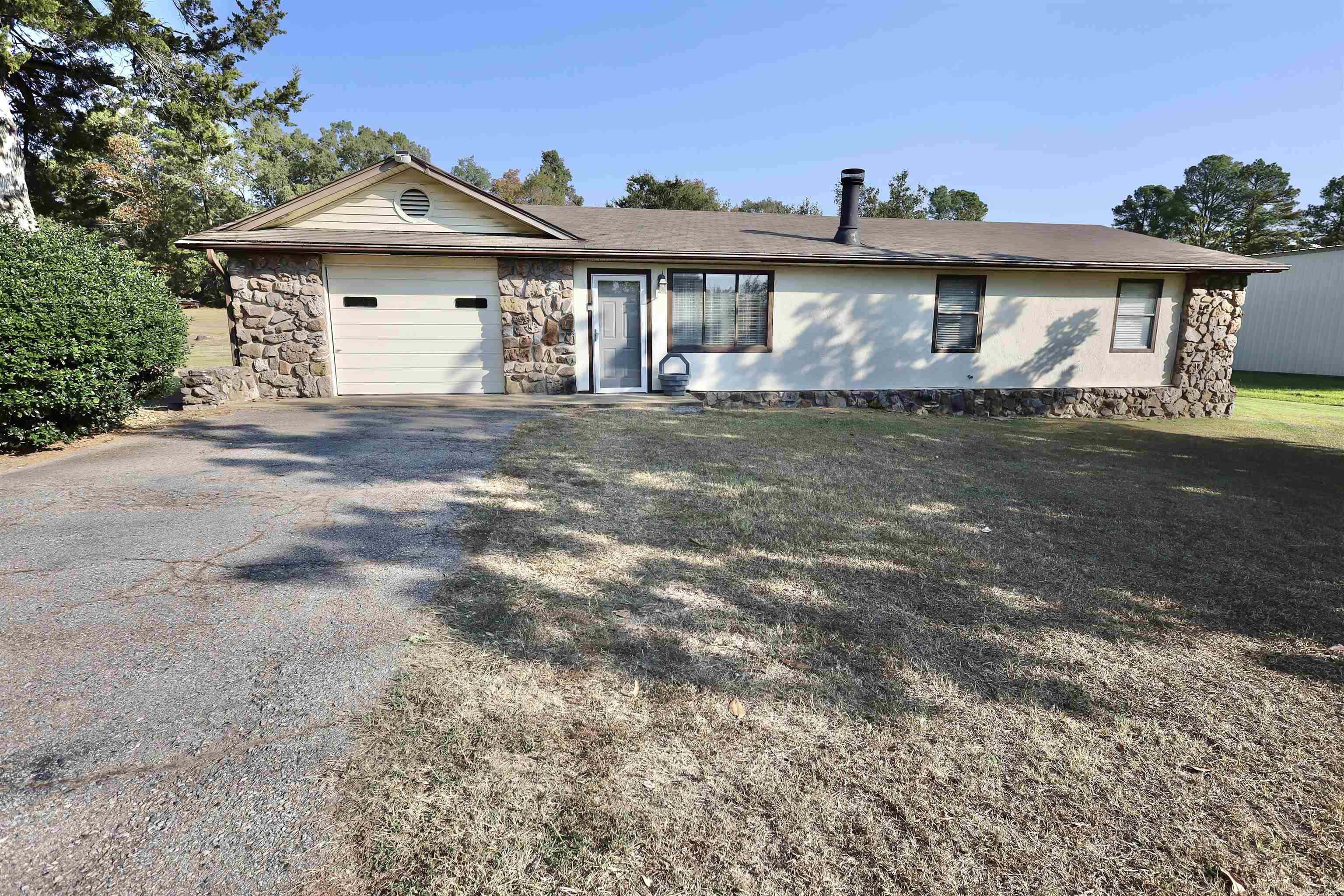 Welcome to this beautifully updated 3-bedroom, 2-bath home located in the Lake Hamilton school district. This charming residence features a cozy rock fireplace, perfect for gathering on chilly evenings, and a fenced yard ideal for outdoor activities and privacy. With its striking rock exterior, this home combines rustic appeal with modern charm. Don’t miss the chance to make this lovely property your own!