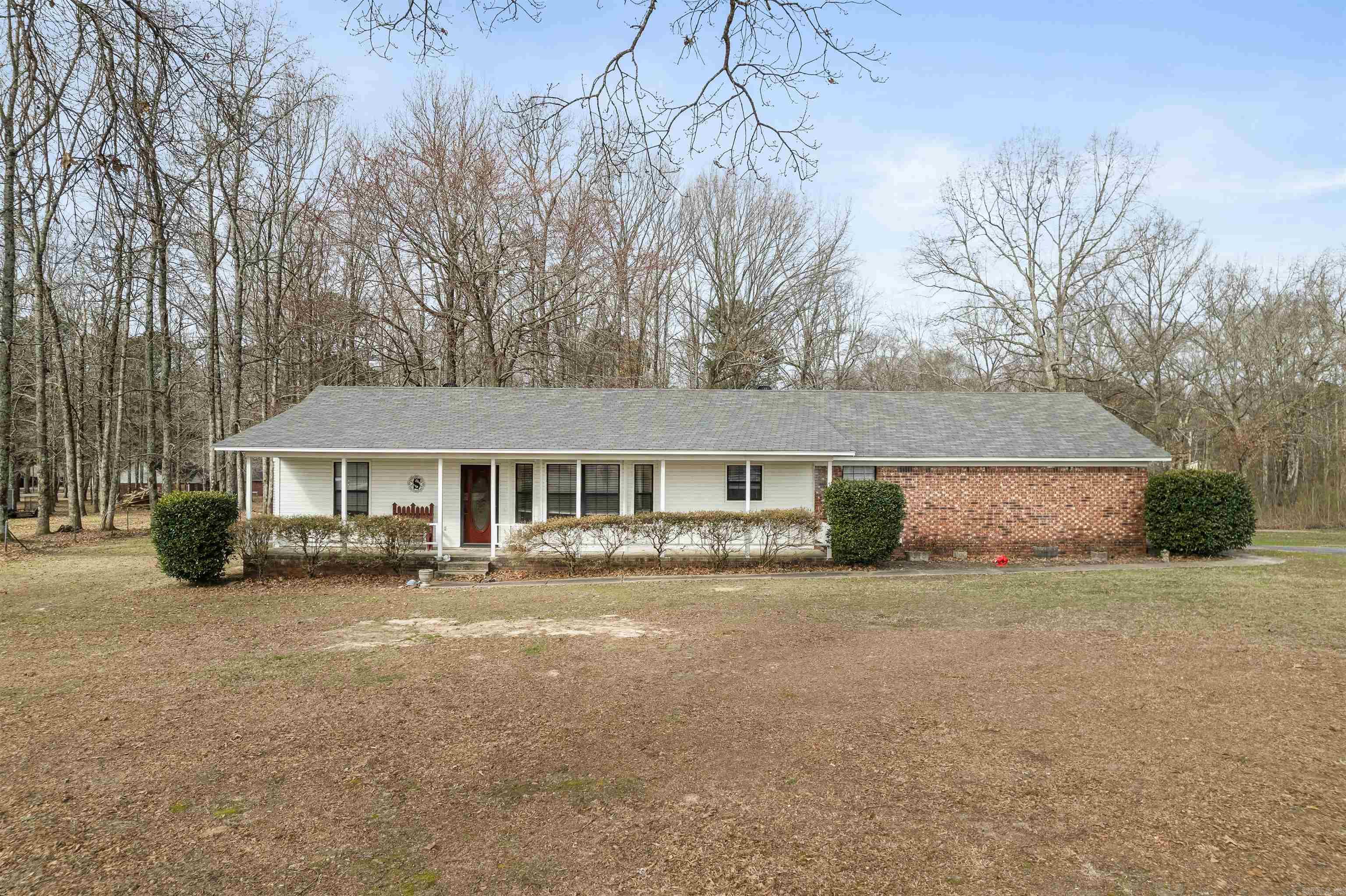 Well-maintained 3 bedroom, 2 bath home featuring a functional split floor plan on approximately 1.3 acres in a quiet setting just outside Cabot city limits. Home offers a large covered front porch, perfect for relaxing and enjoying the peaceful surroundings. Upon entry through the front door, you are welcomed into the foyer. To the left are two guest bedrooms and a full bath. To the right is the spacious living room featuring a wood-burning stove. The living room flows into the dining area and kitchen. The primary bedroom is located off the kitchen to the left, with the laundry room conveniently positioned to the right. Home includes a spacious 2-car garage. The back porch is half screened-in and half open, ideal for enjoying the outdoors. Large backyard is partially fenced along both sides and across the back. Enjoy a quiet country feel while still being just minutes from Cabot and convenient to shopping and amenities. **Professional Photos coming SOON!!