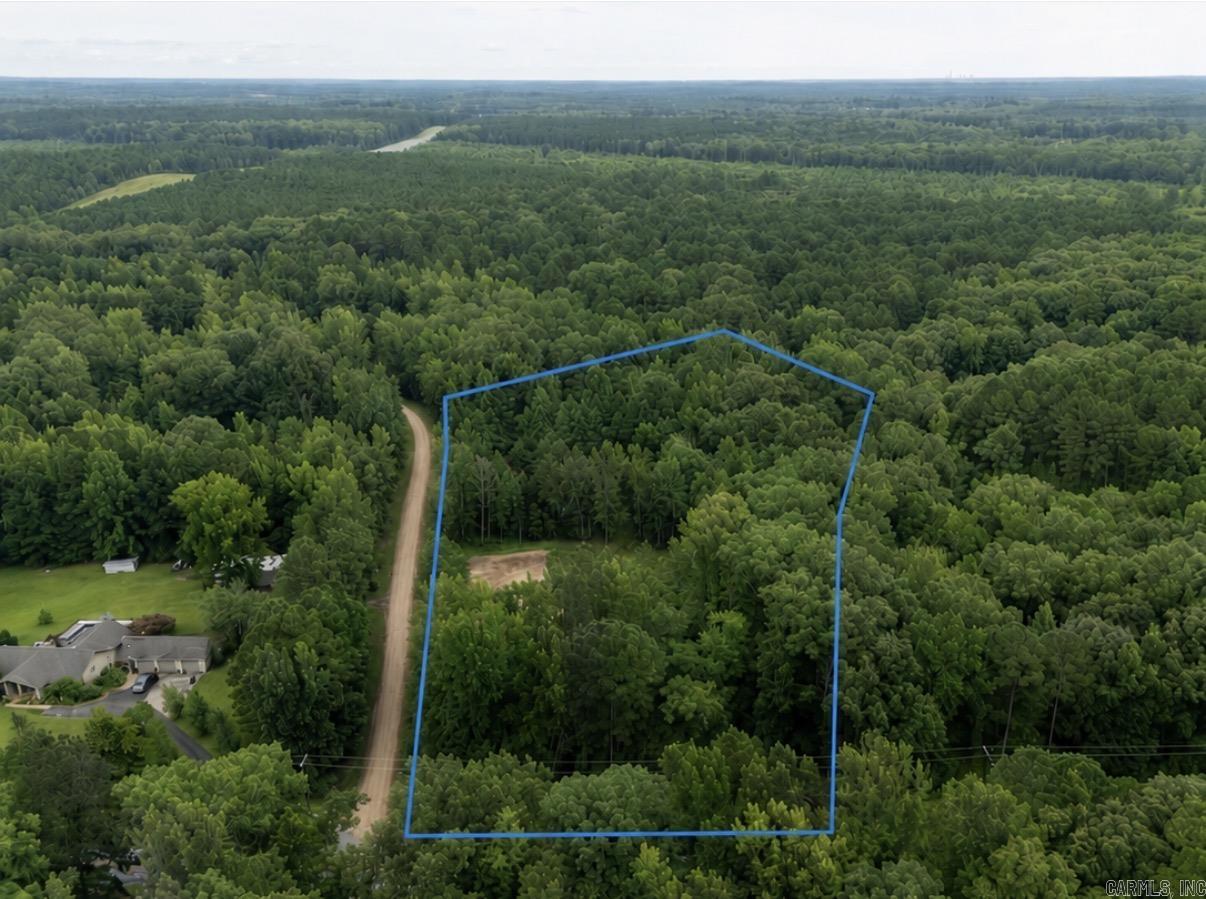Build your dream home on this 8.7± acre property in Sheridan offering the perfect balance of convenience, privacy, and natural beauty. With frontage on both N. Arch Street (Highway 35) and Karen Amy Lane, this property provides excellent accessibility and flexibility when planning your future homesite. The front portion of the property has already been prepared for construction with over an acre cleared, established house and shop pads, a successful perc test, and an elevation survey showing the proposed homesite in a minimal flood hazard area. The wooded back acreage features a pond, scenic creeks, mature timber, and abundant wildlife, creating a peaceful setting with plenty of room to explore, hunt, or simply enjoy nature. Conveniently located just 5 minutes from downtown Sheridan, 25 minutes from Benton, 30 minutes from downtown Little Rock, and less than an hour from Hot Springs and Lake Hamilton, this property offers the tranquility of country living with the convenience of nearby amenities. Whether you’re ready to build your forever home or invest in a beautiful piece of Arkansas, much of the groundwork has already been completed.
