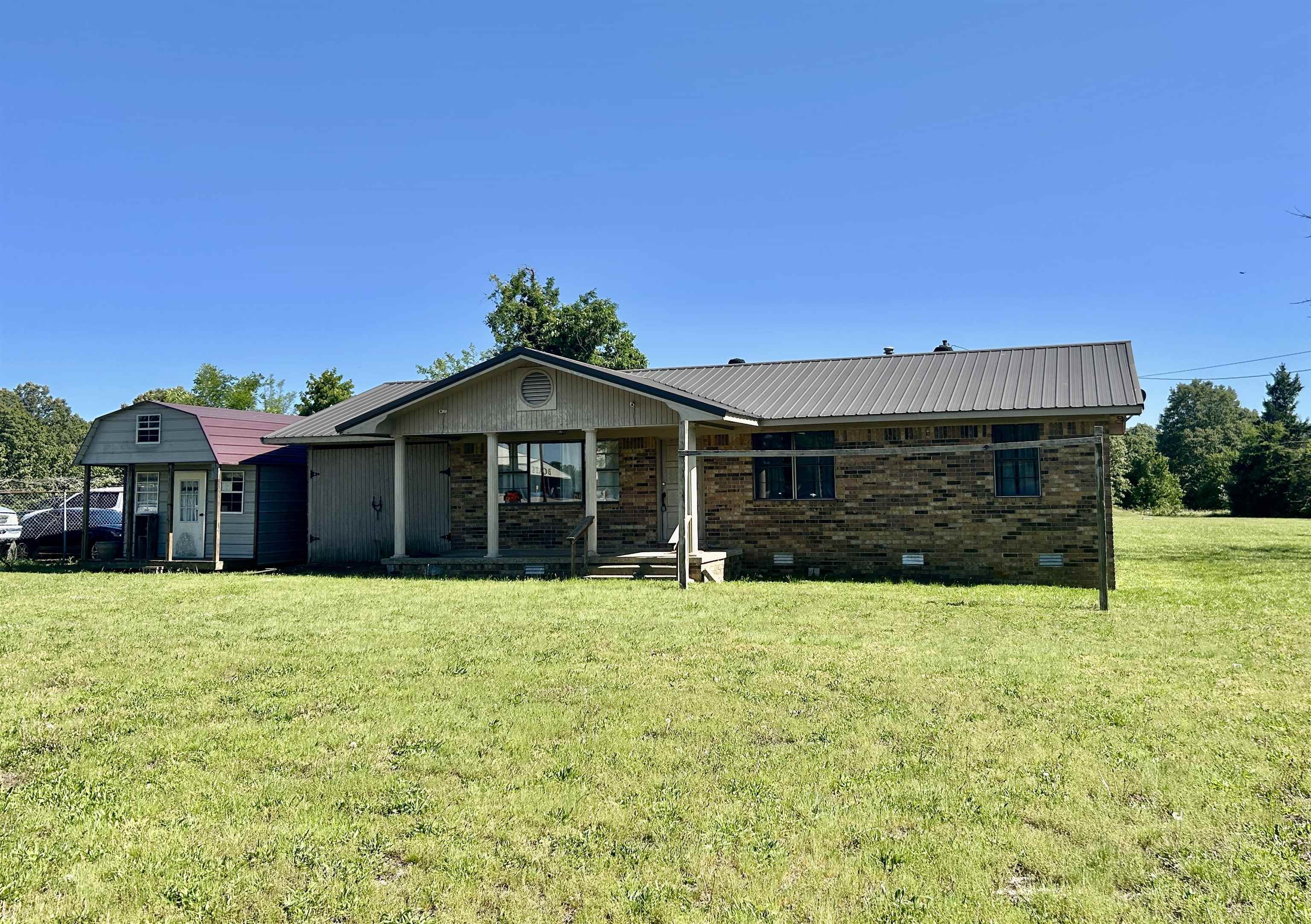 Versatile 3-Bedroom Home on 8+ Acres with Highway Frontage – Highland, AR  This versatile 3-bedroom brick home sits on 8+ acres in Highland, Arkansas, with prime frontage along US Highway 62/412, making it suitable for residential living or potential commercial use. The property includes a 1-car garage and a 6’ x 10’ storage shed, offering ample space for tools, equipment, or extra storage needs.  The mostly cleared, level acreage provides plenty of room for expansion and is well-suited for a horse or two. Conveniently located between Ash Flat and Hardy, this property offers excellent accessibility while maintaining a rural feel. City water and sewer are already in place, adding to the property’s value and convenience.  Whether you’re looking for a home, business location, or investment opportunity, this property offers flexibility, visibility, and room to grow.