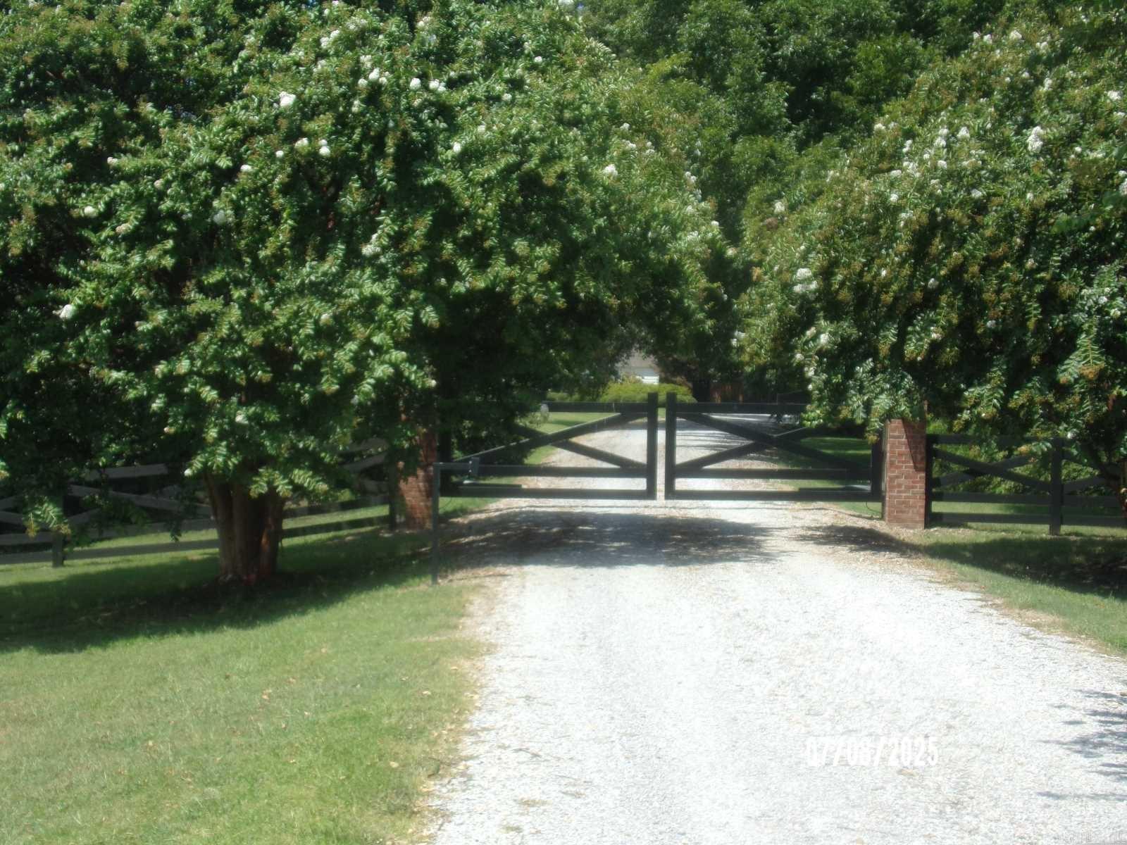 Discover a rare opportunity to own 26 breathtaking acres that perfectly blend luxury living, privacy, and endless potential. This stunning residential property features a beautifully  homesite to build your dream home ,complete with a sparkling pool ready to jump into and enjoy all summer long. The property also includes a separate in-law quarters/guest house, ideal for extended family, visitors, or private accommodations. As you enter through the secure electric gated entrance, you’re welcomed by gorgeous mature landscaping, peaceful surroundings, and a sense of true country elegance. The main homesite for you to build  is fenced for privacy and comfort, while the additional 20 acres of rich, cultivating land offer endless possibilities for farming, recreation, horses, development, or simply enjoying wide open space. Whether you’re searching for a private family estate, multigenerational property, hobby farm, or investment opportunity, this one-of-a-kind 26-acre retreat offers the perfect balance of beauty, function, and serenity.