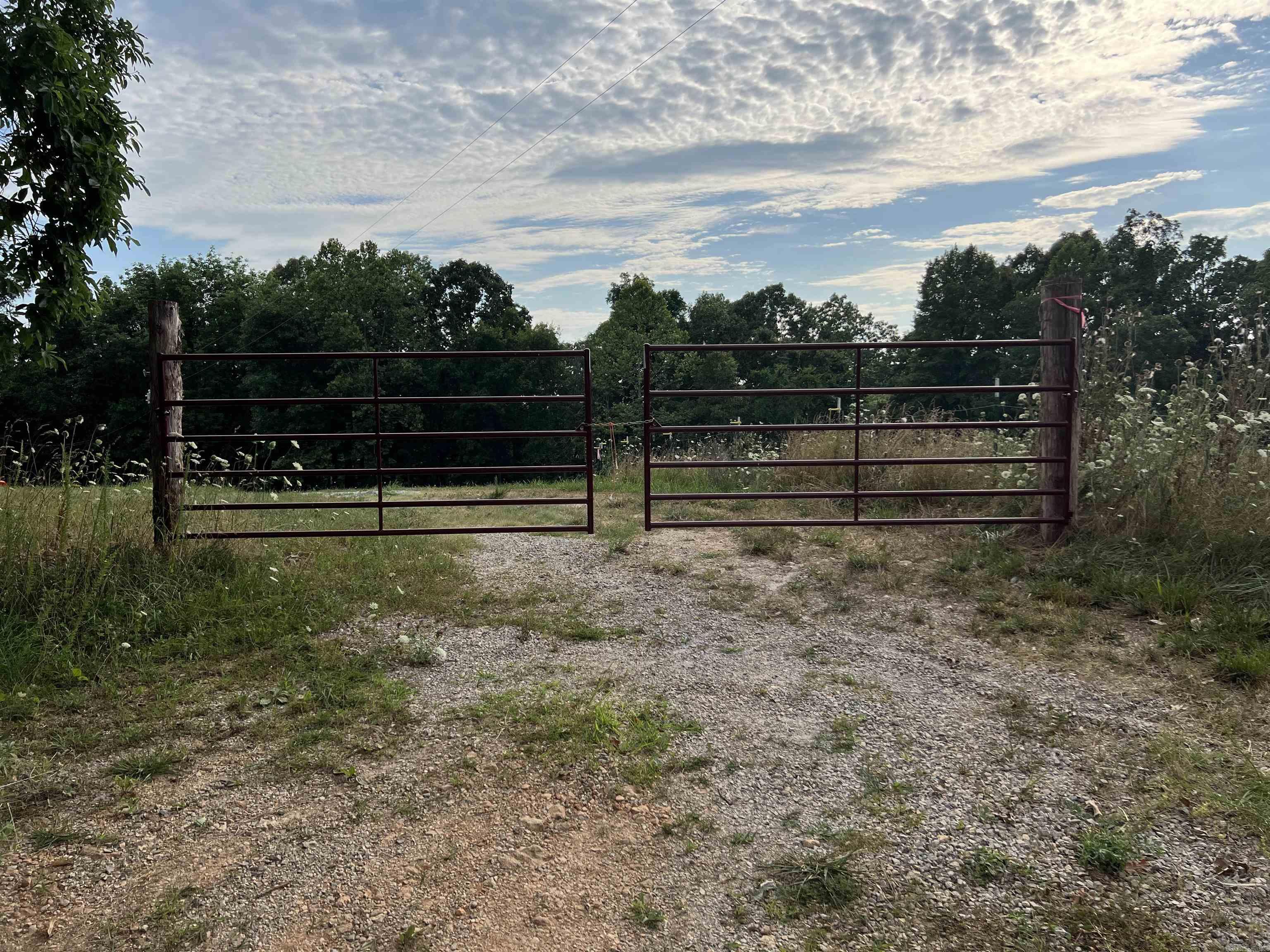 Ozarks hunting and recreational property located at 1717 Grassy Road near Marshall, Arkansas. This versatile tract has been developed with hunting in mind and features established food plots, watering holes, and excellent habitat for deer, turkey, bear, hogs, and small game. The property offers a beautiful mix of open fields, mature timber, rolling hills, bluffs, a wet-weather creek, and a natural spring. Existing hunting cabins provide immediate use and there are multiple potential building sites for a cabin, lodge, or home. Electricity, public water, and high-speed fiber internet are available, combining rural seclusion with modern conveniences. Conveniently located near Marshall and the world-famous Buffalo National River, this property is ideal for hunting, recreation, ATV riding, hiking, or creating your own private Ozarks retreat.