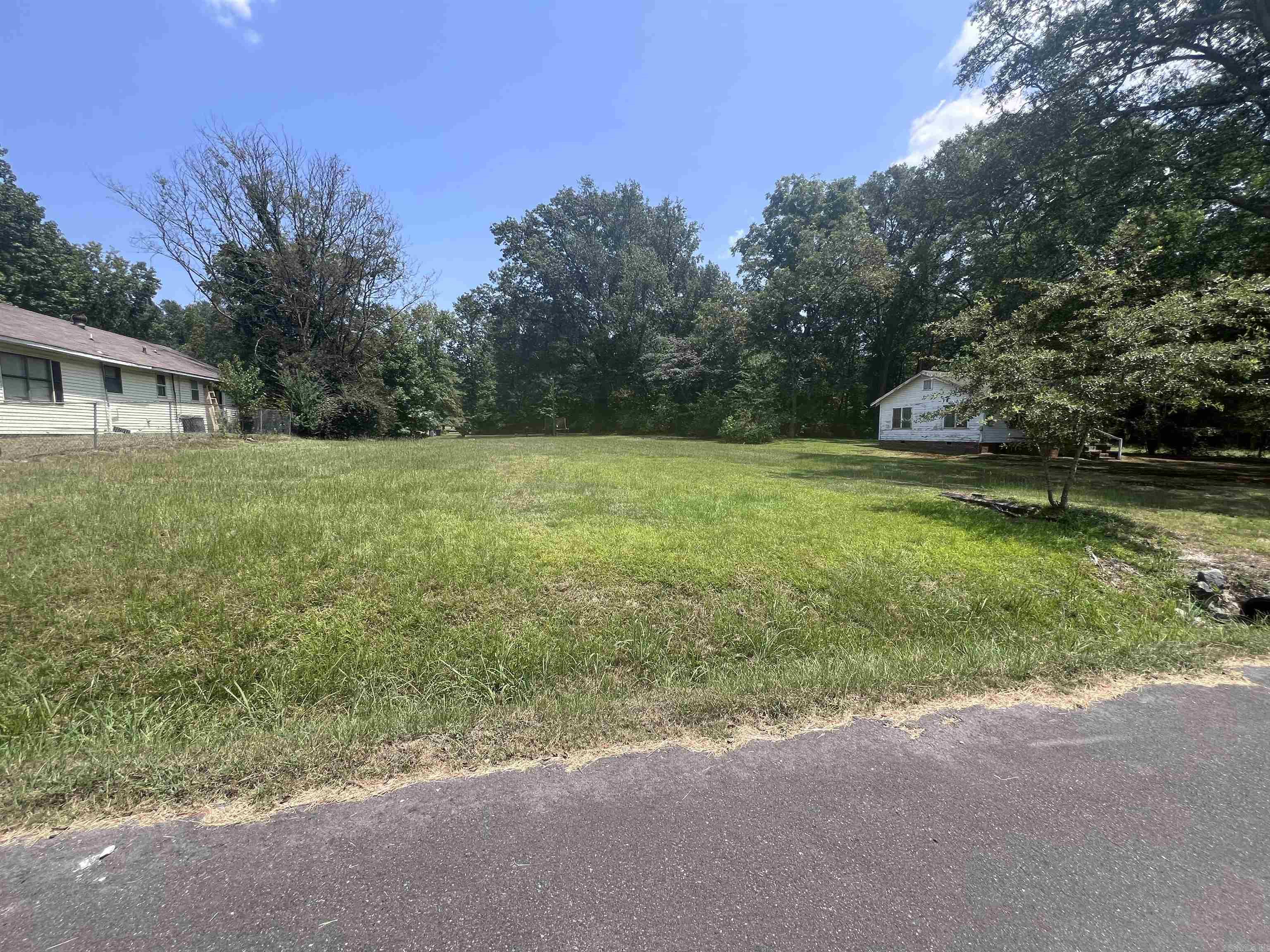Beautiful flat lot. Double wide mobiles are allowed with city water/sewer. Buyer to verify. Great rental development opportunity or build/place your own home!