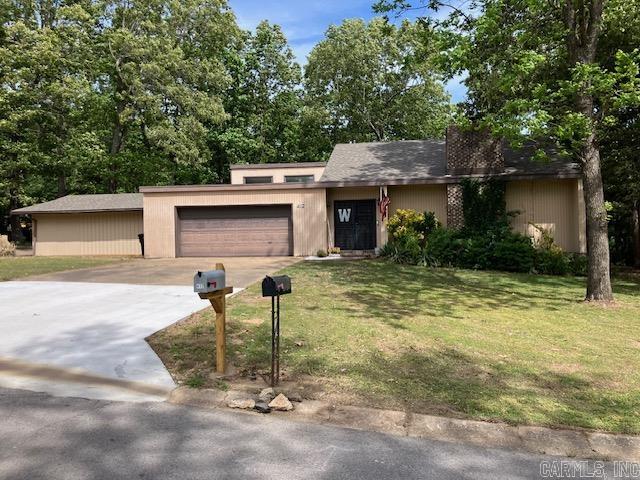 This 2200+ square foot, brick and siding 4BR/2BA home features a large living room with vaulted ceiling and a gas log fireplace. The kitchen features quartz countertops, tile backsplash, double wall ovens and a gas cooktop along with a large pantry and tile floors.   Another nice feature is the outdoor space Atrium, perfect for cooking, gatherings and more in private. Keeping in theme with the architecture style, the ceilings are tall and have lots of high windows for an abundance of natural light in the home.   The master suite features a walk in closet and a dual sink, mirror, and lighting vanity, tiled bathroom and shower walls. The two car garage plus two car enclosed carport allows for covered parking for up to four vehicles. For additional piece of mind, the roof was replaced in 2022 and the water heater in 2025.   This home is located in a great, quiet neighborhood and the large lot offers plenty of outside space complete with shade trees perfect for outdoor activities.