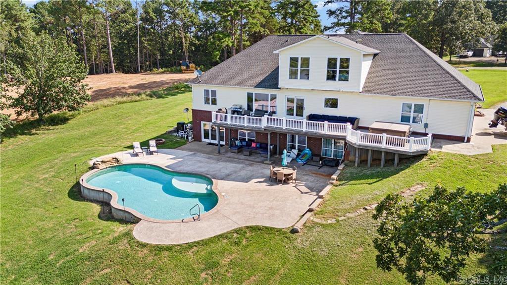 POWERFUL PRESENCE--stunning, cliff top dwelling overlooking the Arkansas River! CUSTOM BUILT home offers sweeping views, waterfront ambience, and golden sunsets. Well-designed aesthetics have maximized its location as a water front domain. Main level offers huge windows and new flooring throughout. Formal dining room, additional coffee bar, massive office with built ins, well-designed kitchen w/ bar, 1 of 2 living rooms are also on main level. Exceptional view of the water from the primary suite--offers a room that is the walk in closet plus an extremely spacious bathroom. Downstairs offers a huge living room plus game/exercise room, bedroom, laundry room, bonus rooms. Walk out to the self-cleaning, saltwater pool with water fall. Extra pavilion for entertaining.